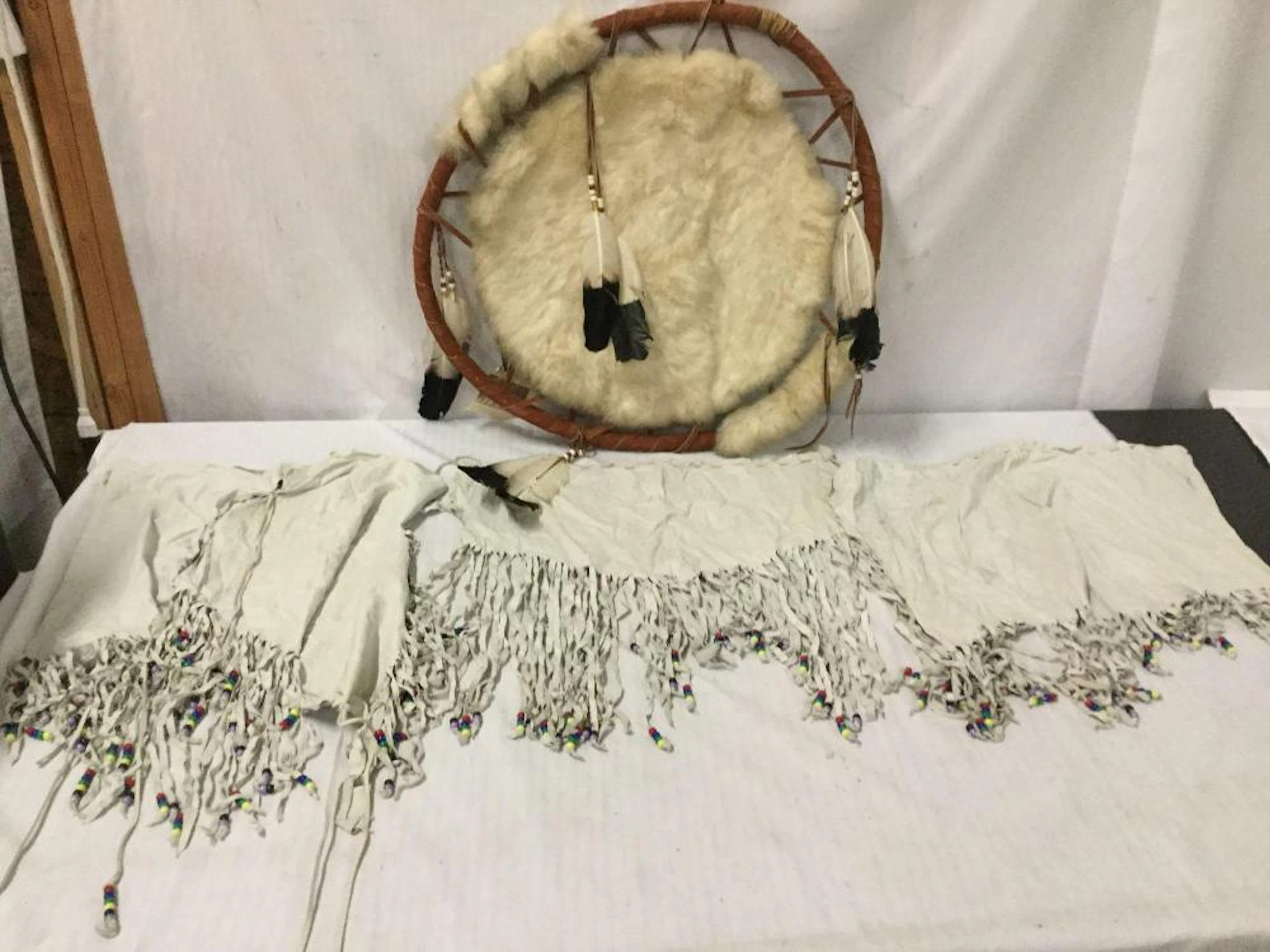 Native American handmade cowhide with feather accents war...