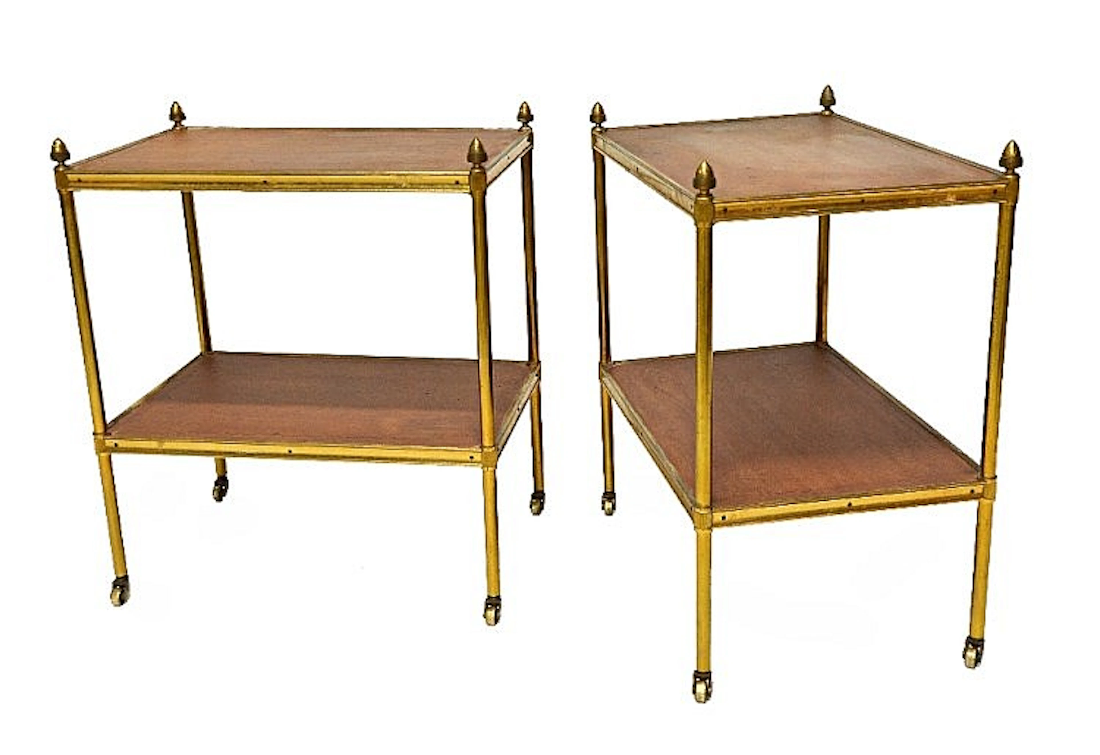 A pair of early 20th century rectangular two tier tables with leather inser