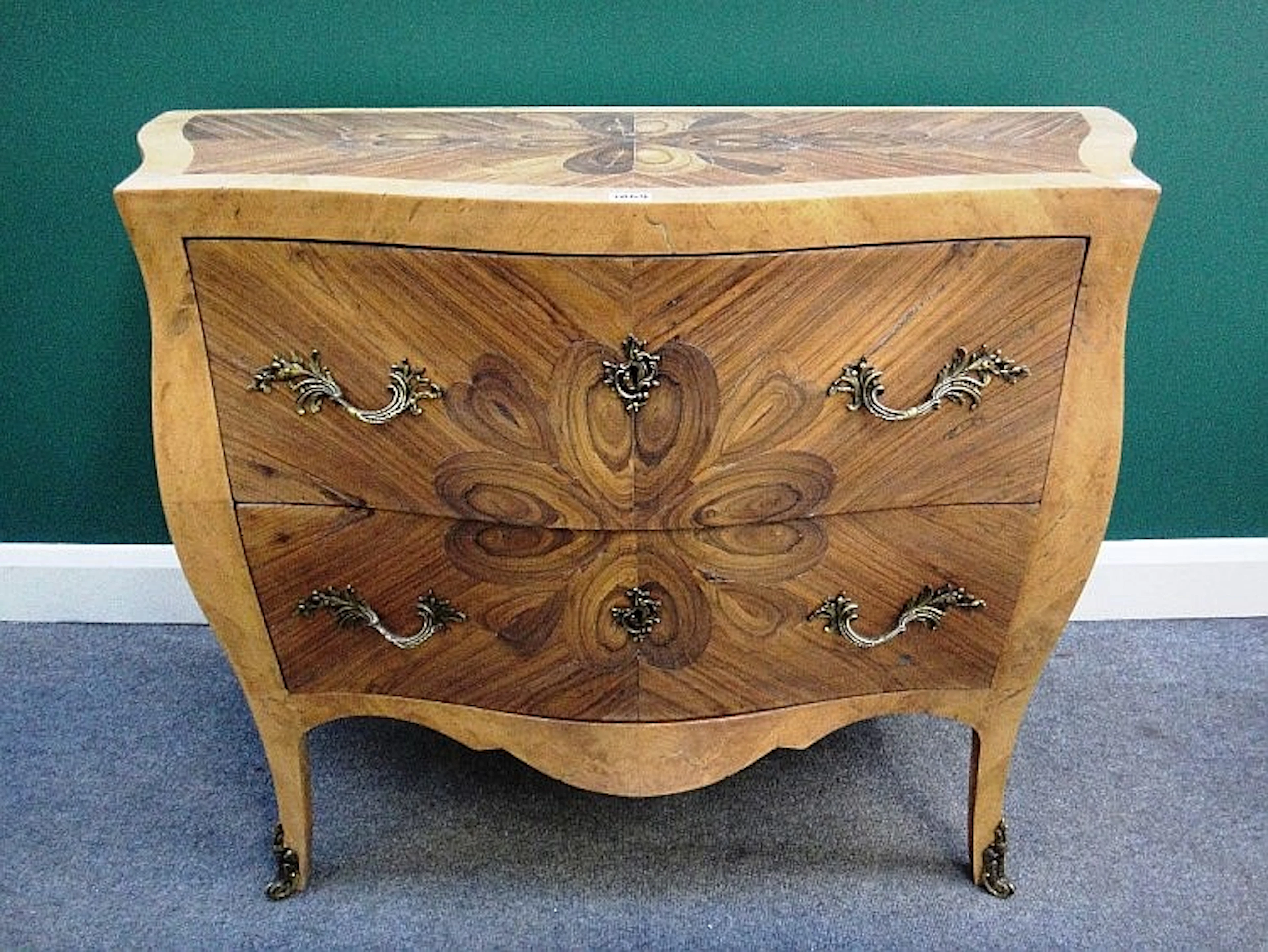 An 18th century style amboyna oyster inlaid gilt metal mounted walnut bombe