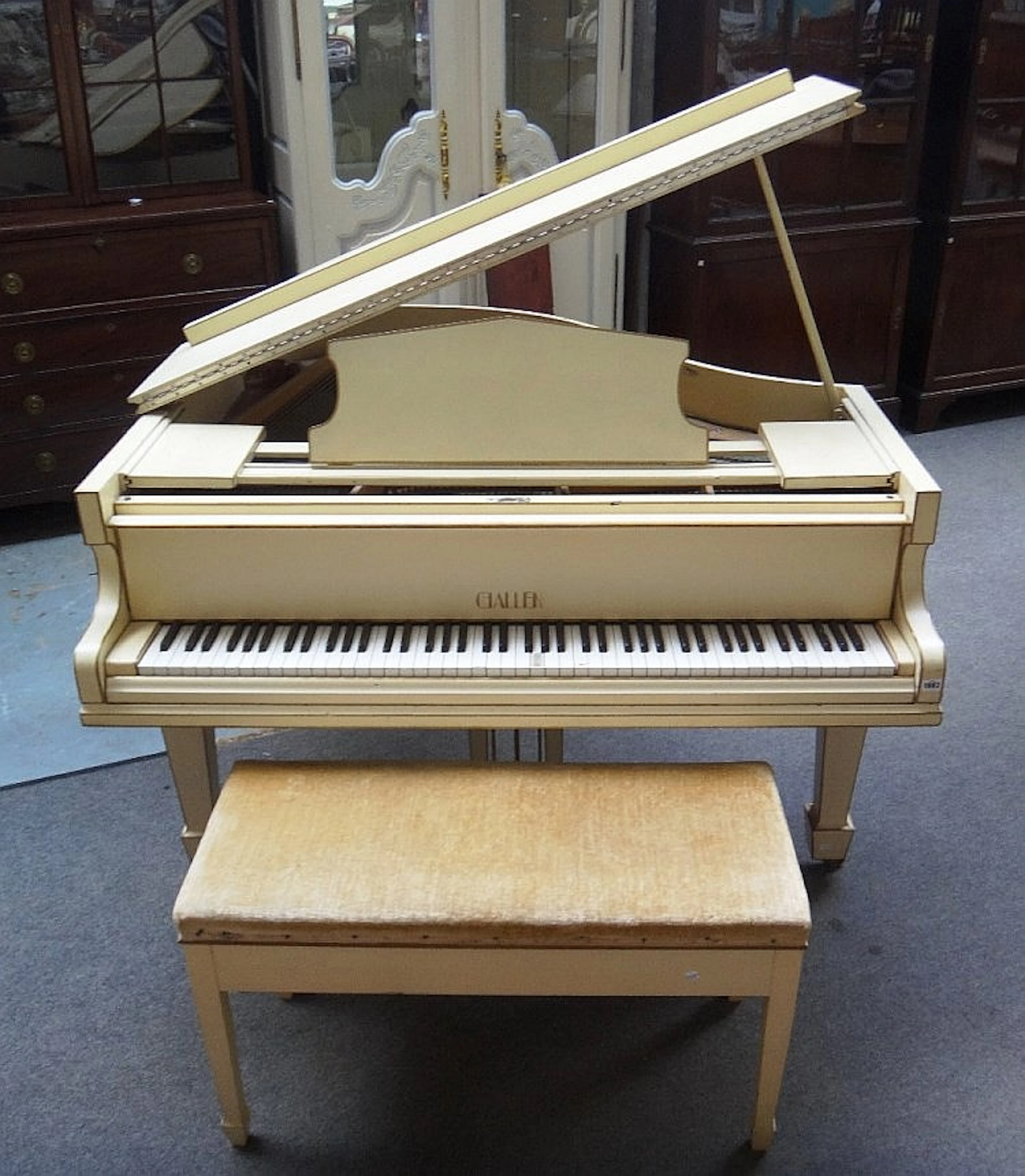 A white painted iron framed over strung baby grand piano by 'Challen' on ta