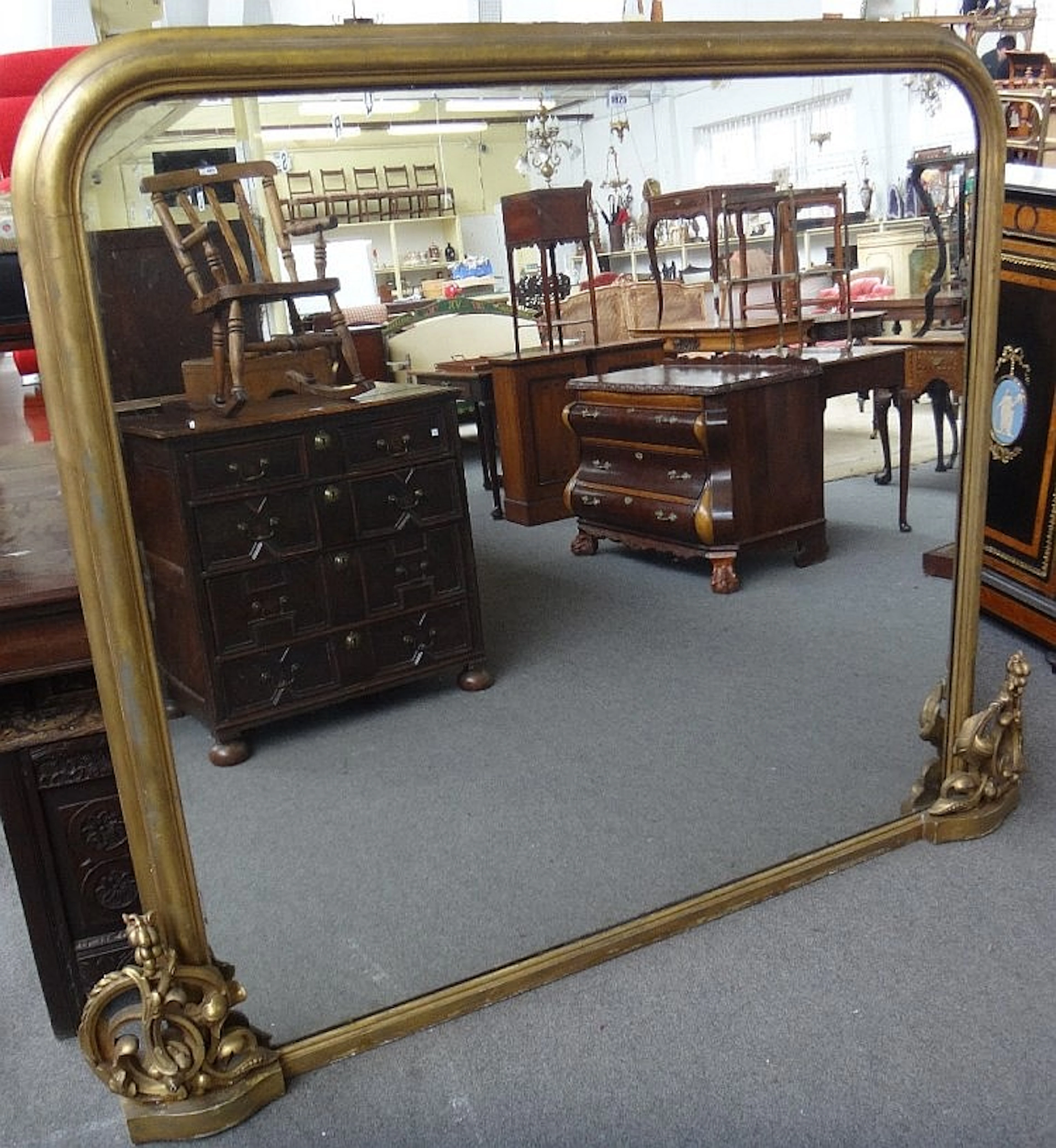 A large Victorian gilt framed rounded rectangular overmantel mirror with ca