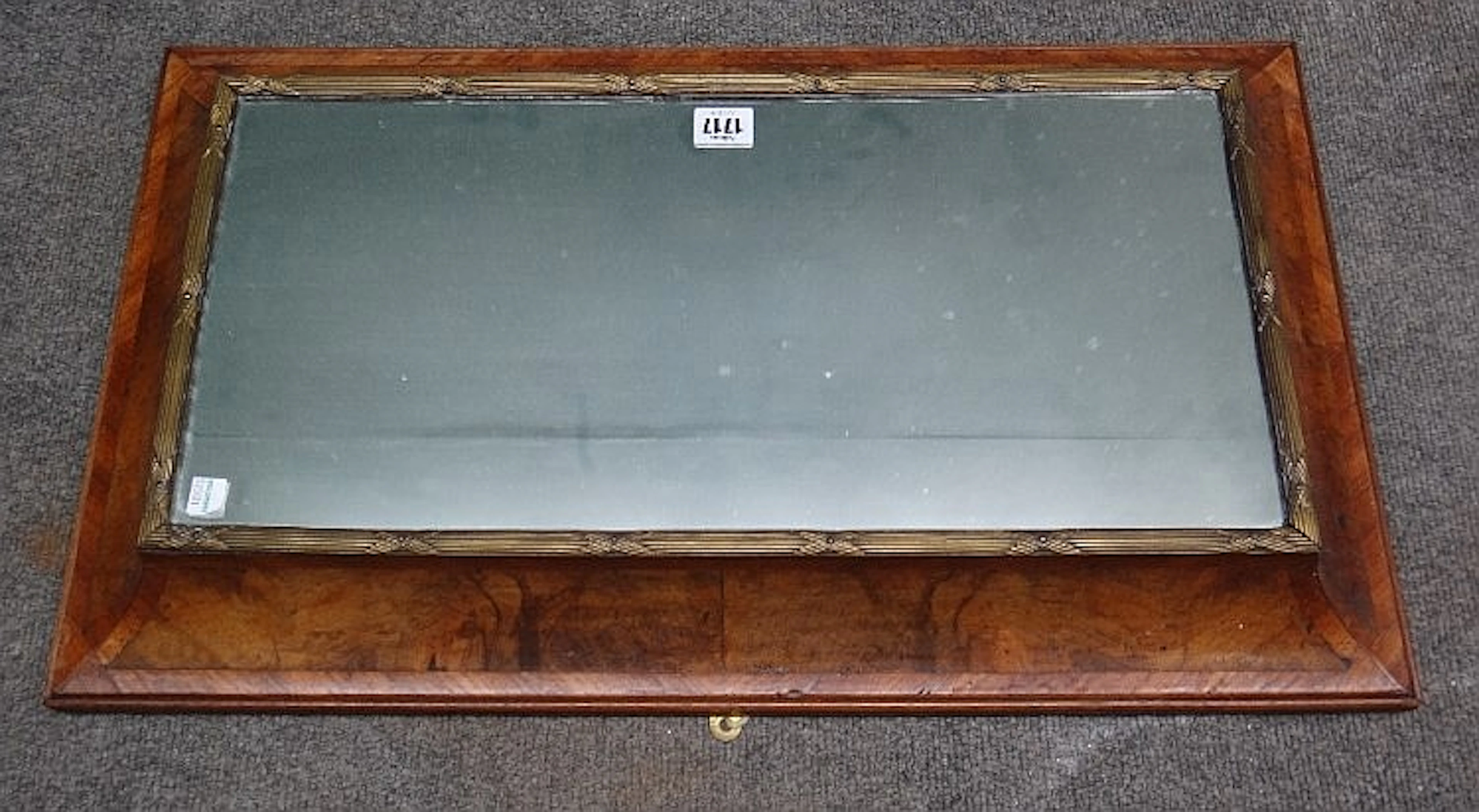 A gilt metal mounted figured walnut cushion framed rectangular mirror, 67cm