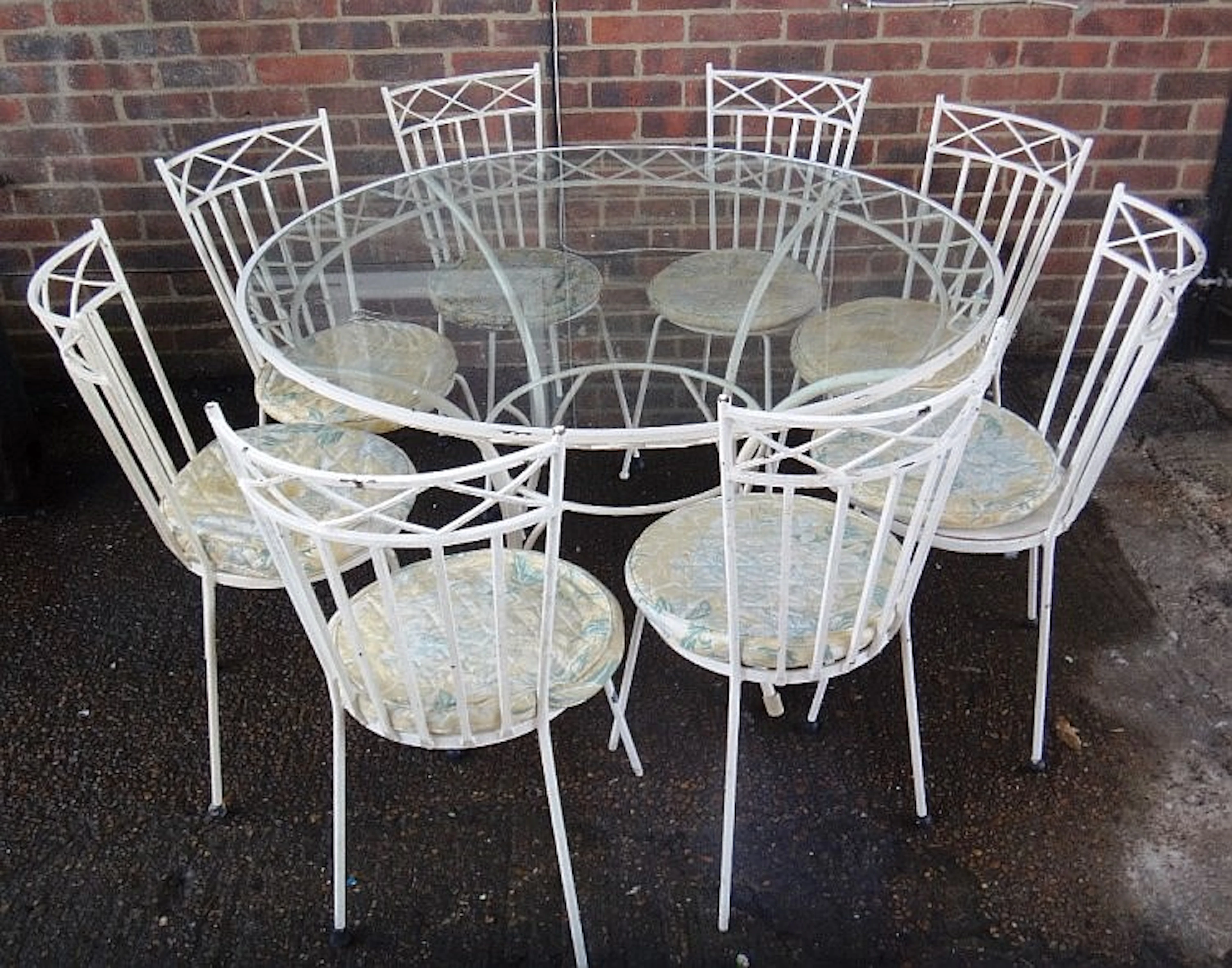A 20th century white painted metal glass topped circular garden table, 125c