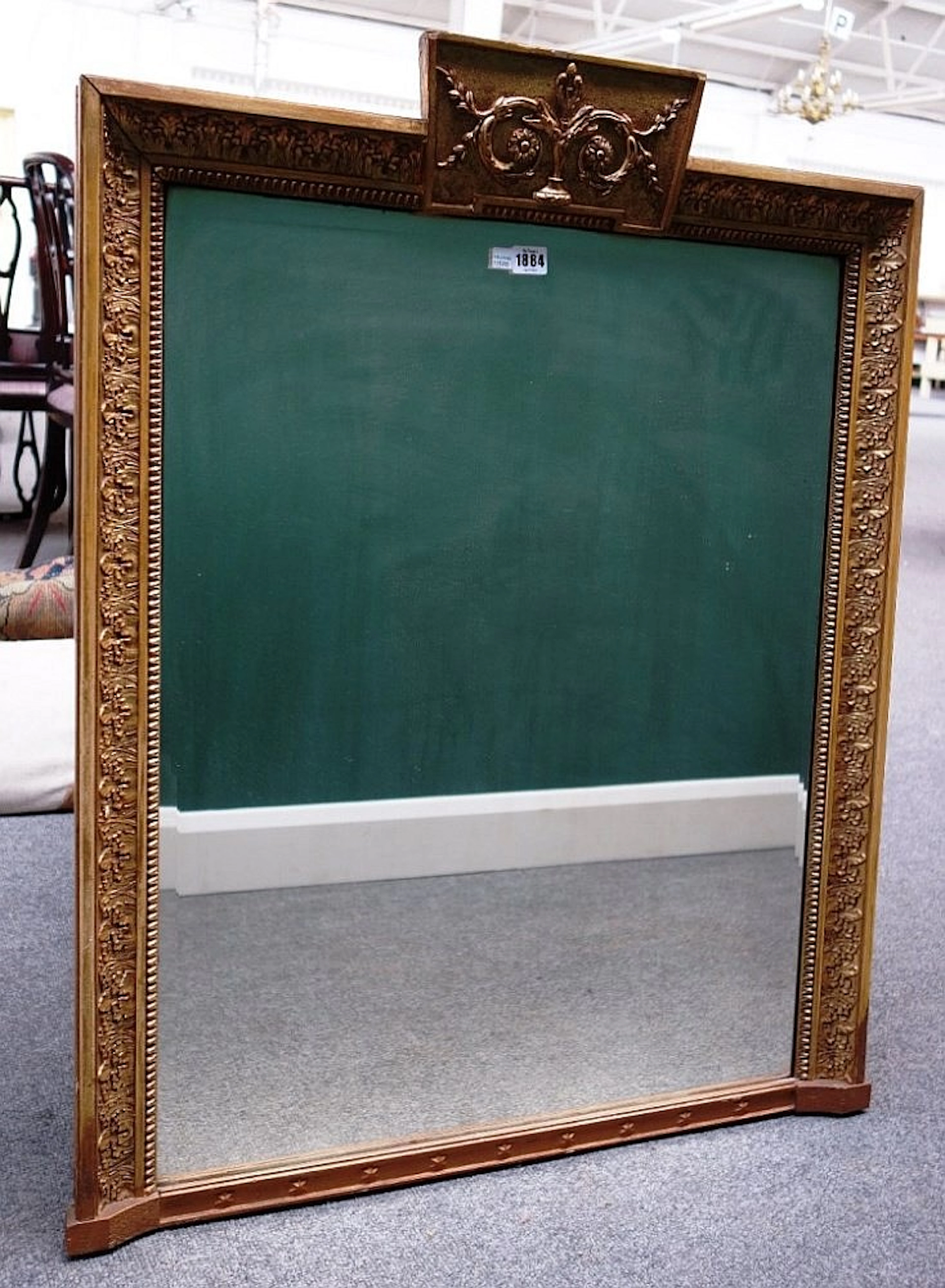 An early 20th century rectangular gilt framed mirror with tablet crest rail