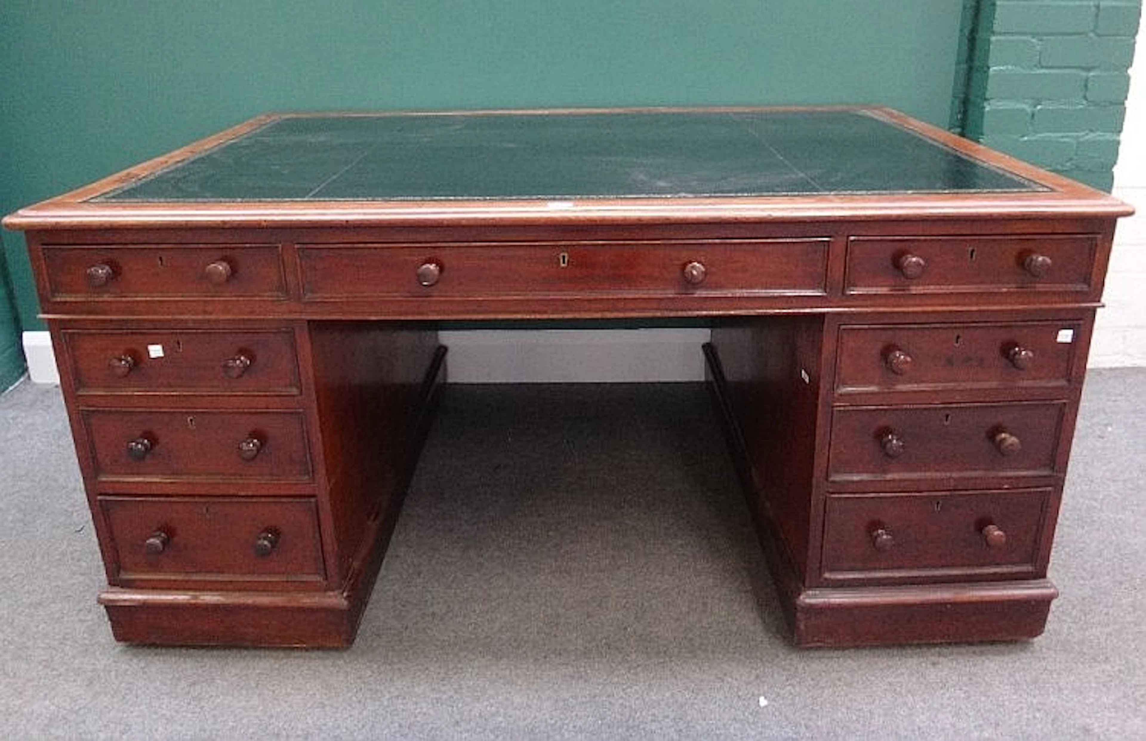 A Victorian mahogany partners pedestal desk with nine drawers about the kne