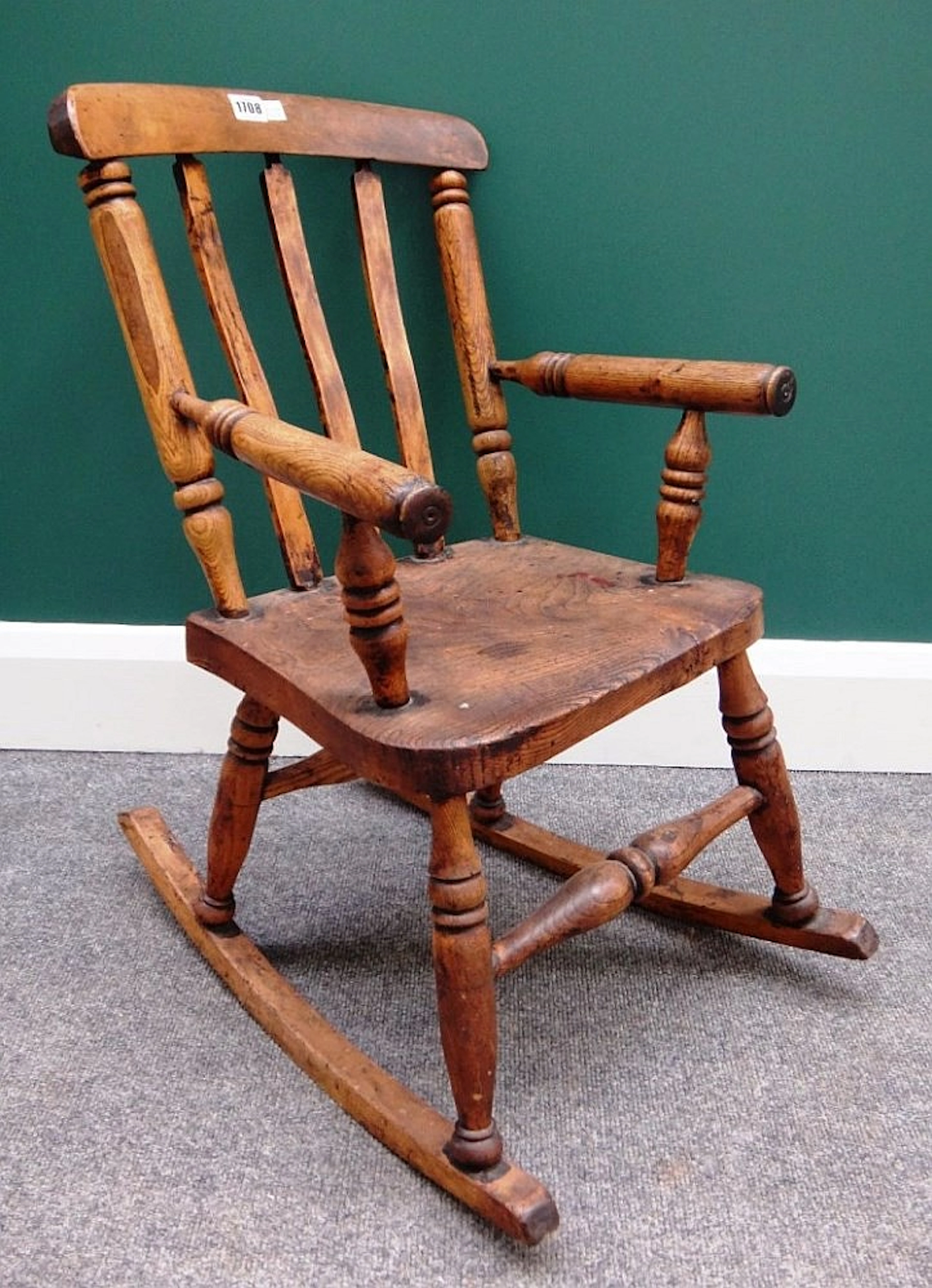 A 19th century child's ash and elm rocking chair, with turned supports, 67c
