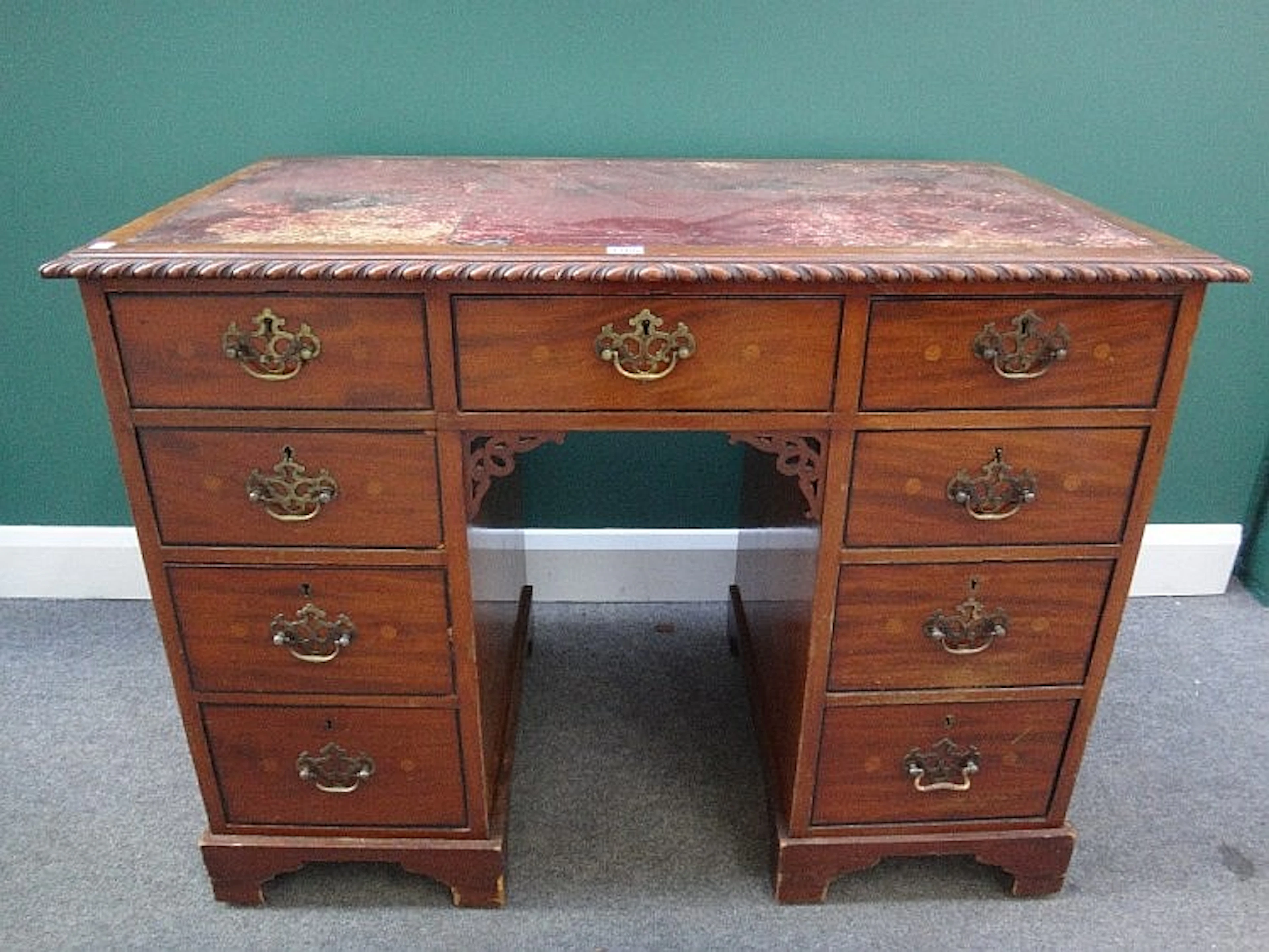 A late 19th century mahogany writing desk, the gadrooned top over nine draw