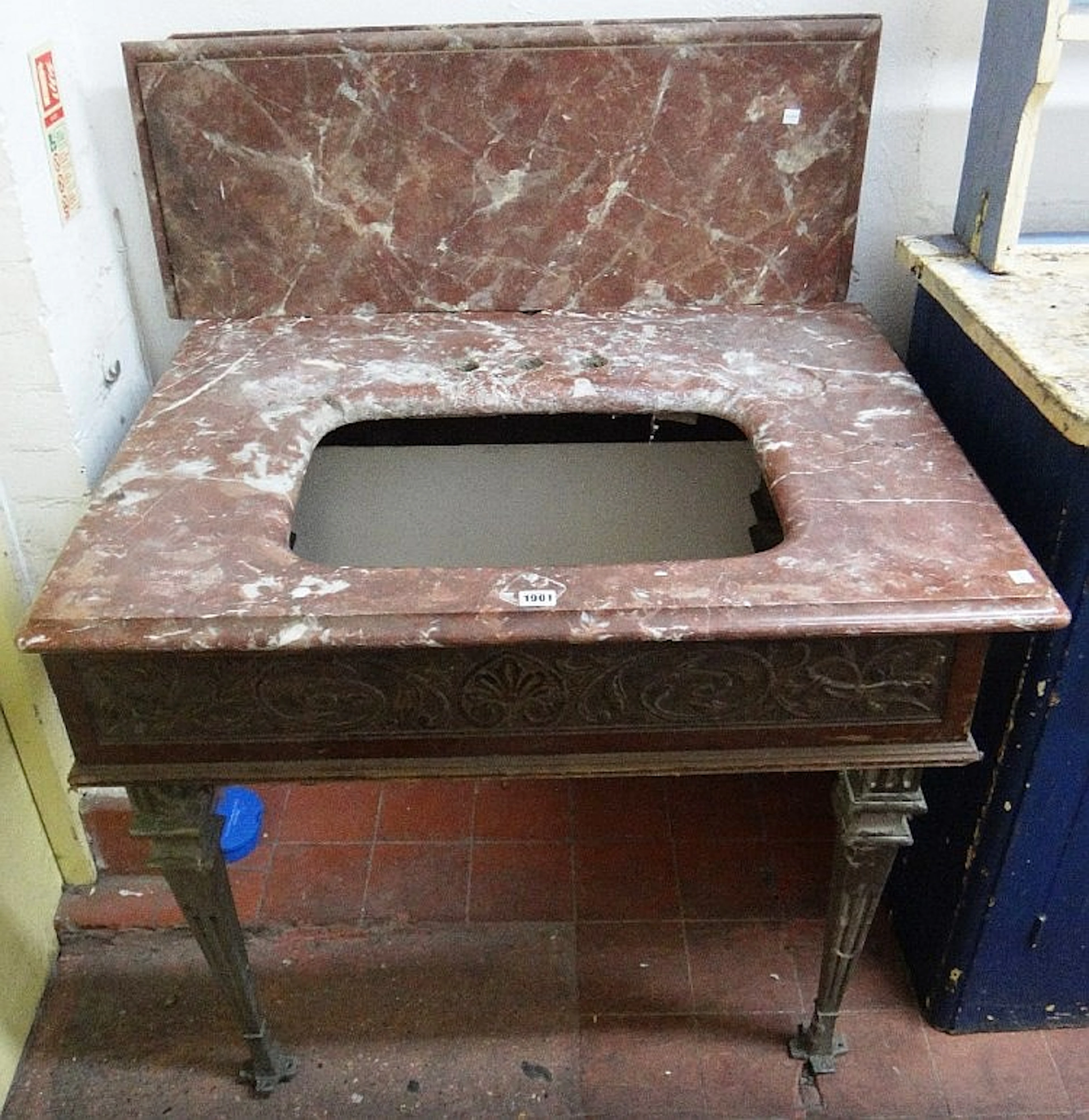 An early 20th century sink unit, with rouge marble splash back and surround