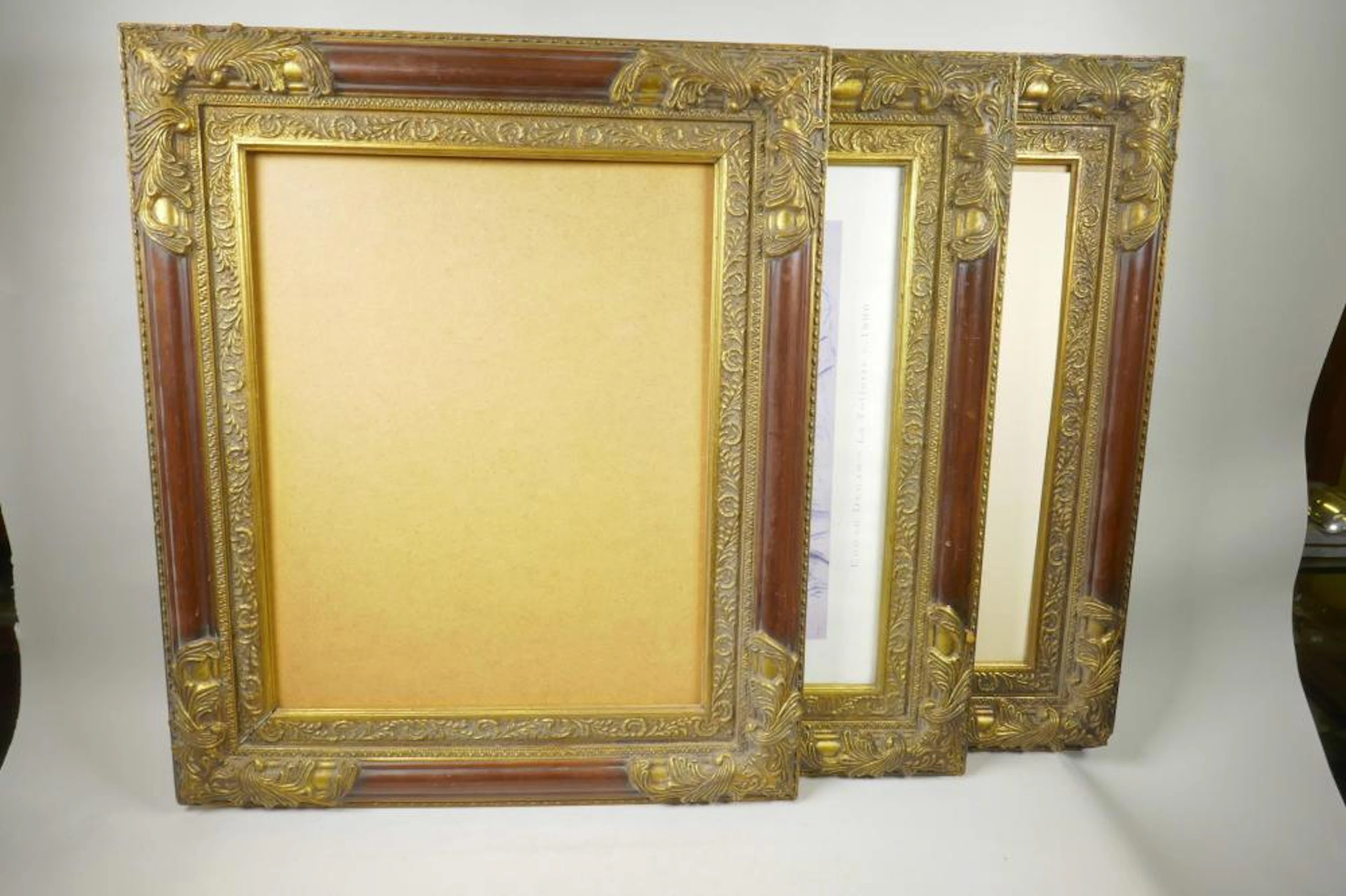 A set of three moulded and parcel gilt picture frames
