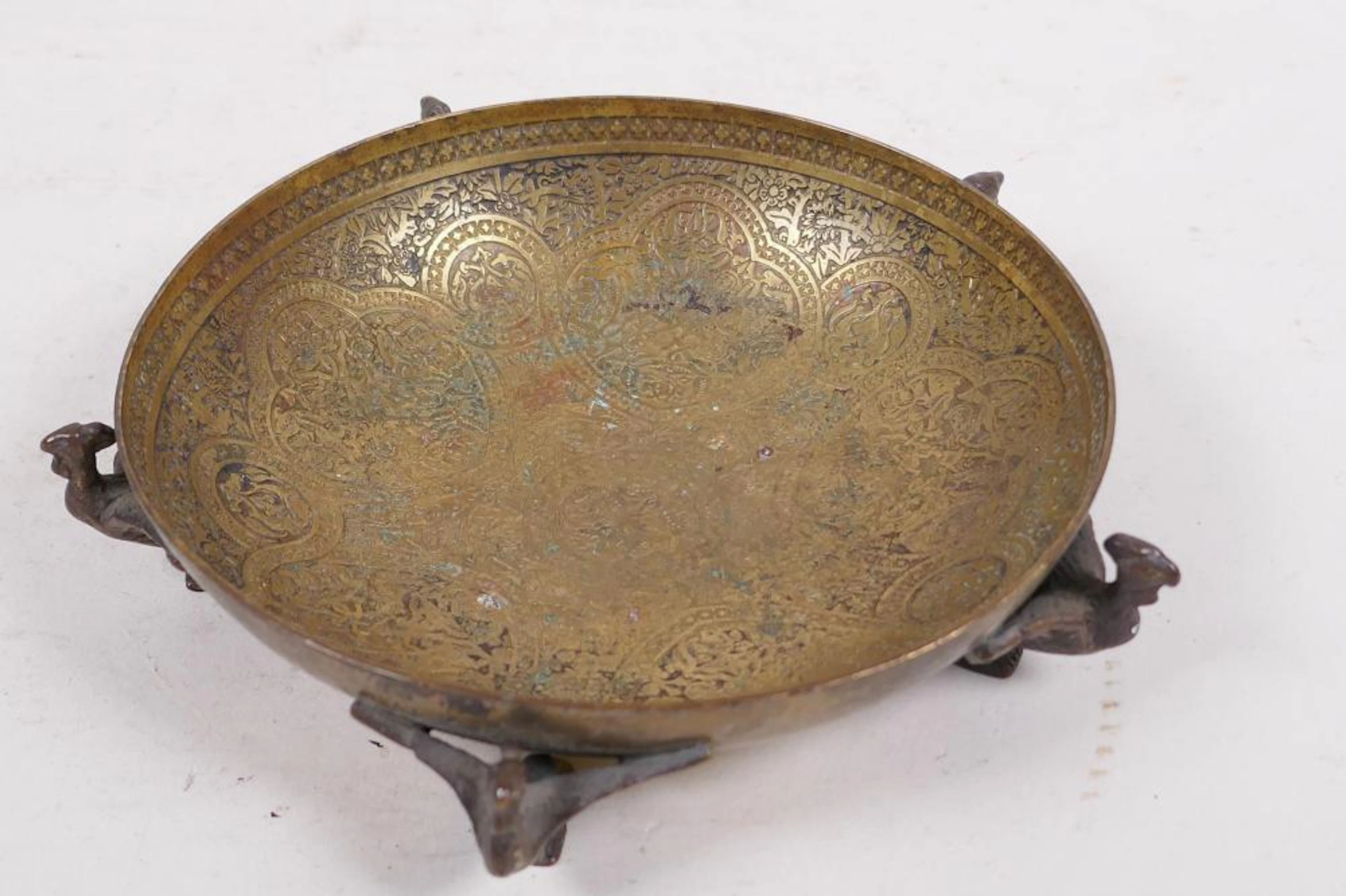 A small engraved brass bowl with Egyptian revival...