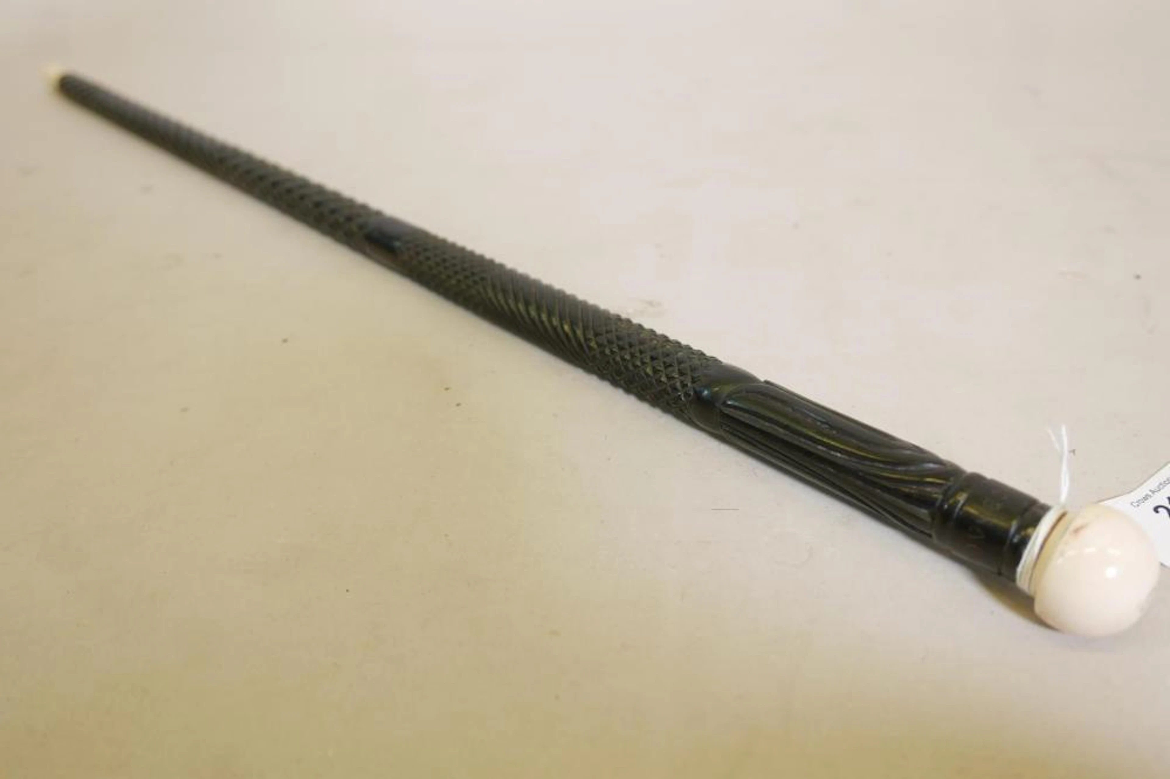An Anglo Indian carved ebony swagger stick with ivory mounts