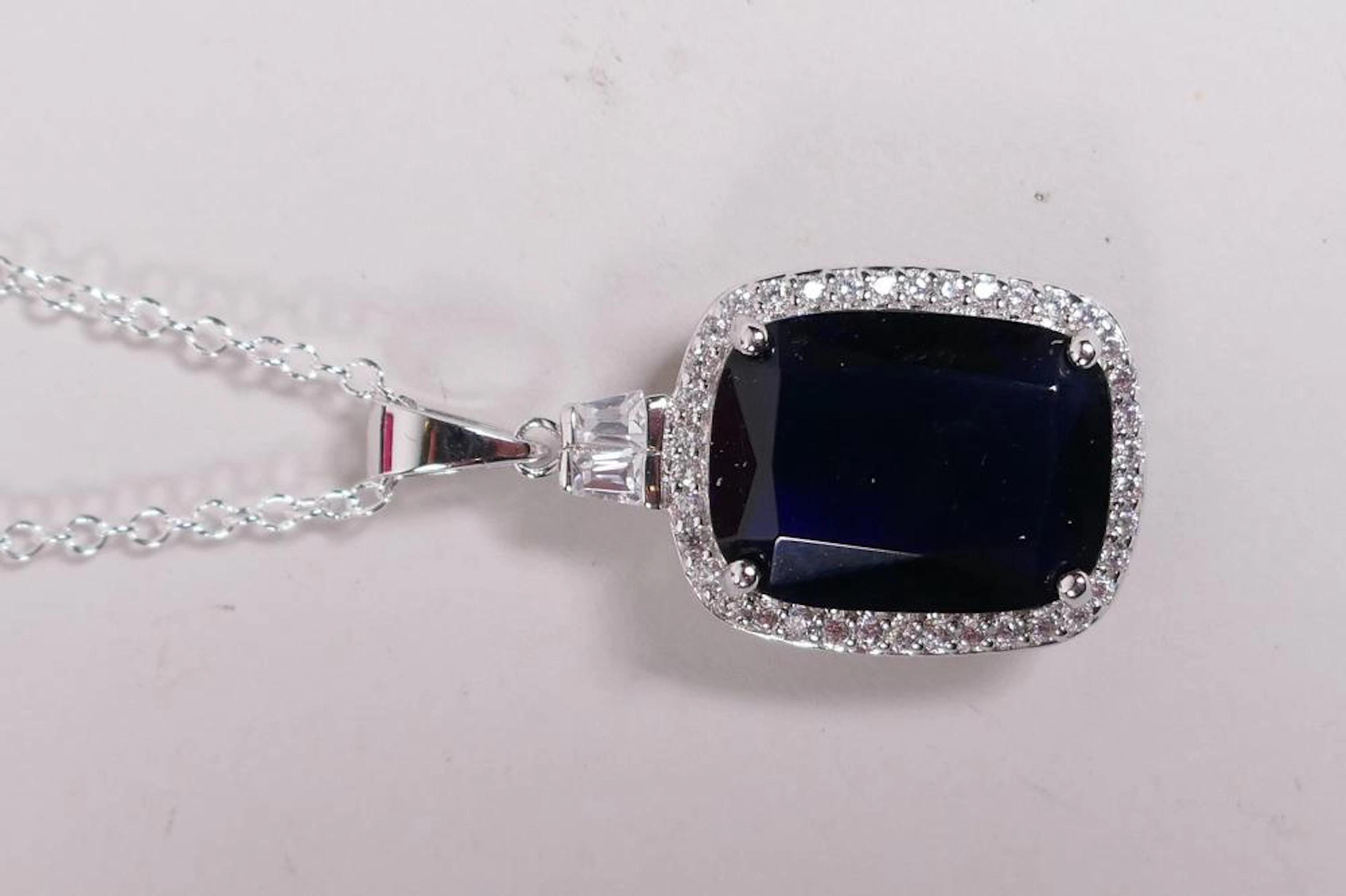 A 925 silver and large faux sapphire pendant necklace...