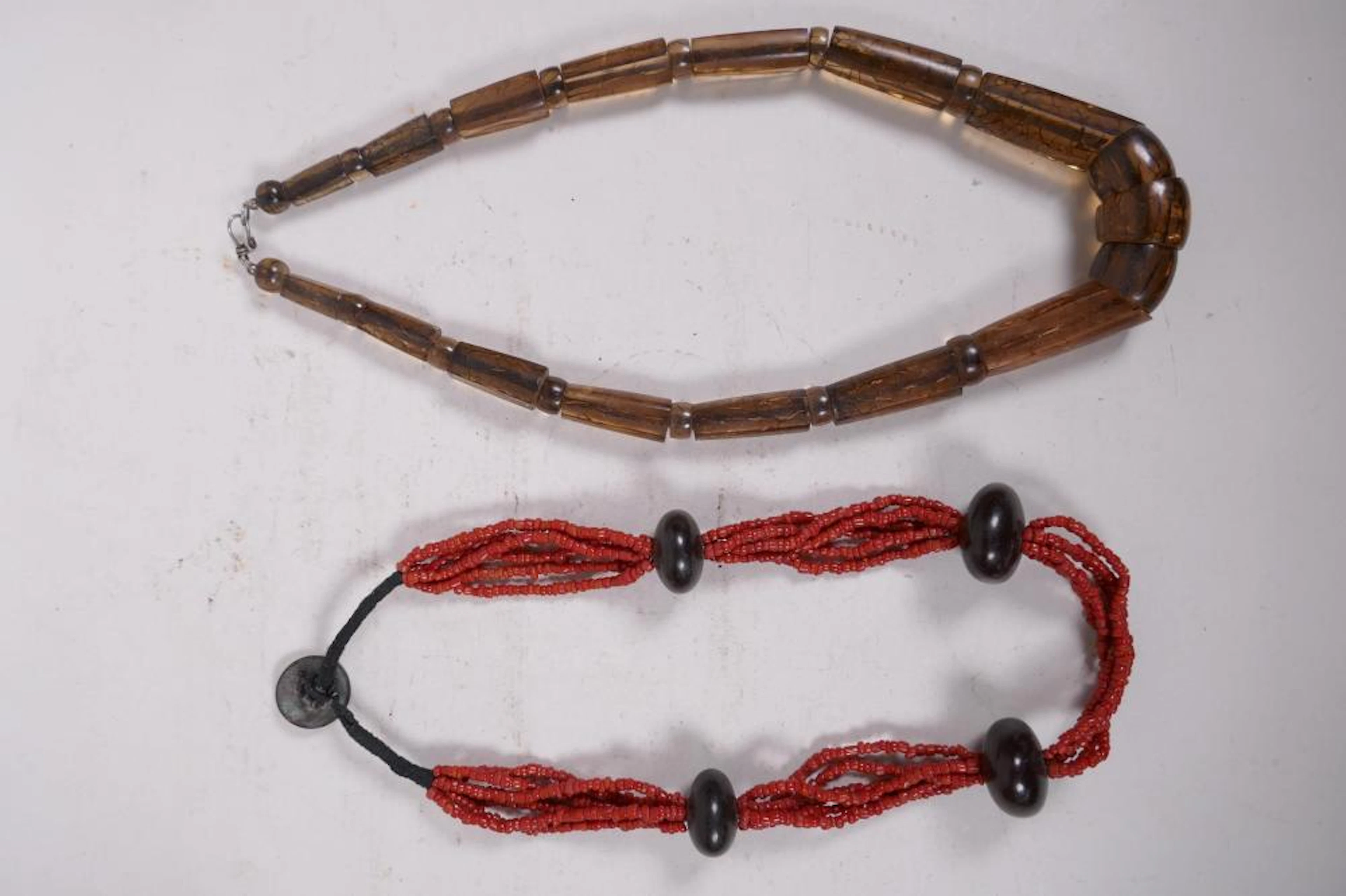 A multistrand beaded necklace with four feature beads