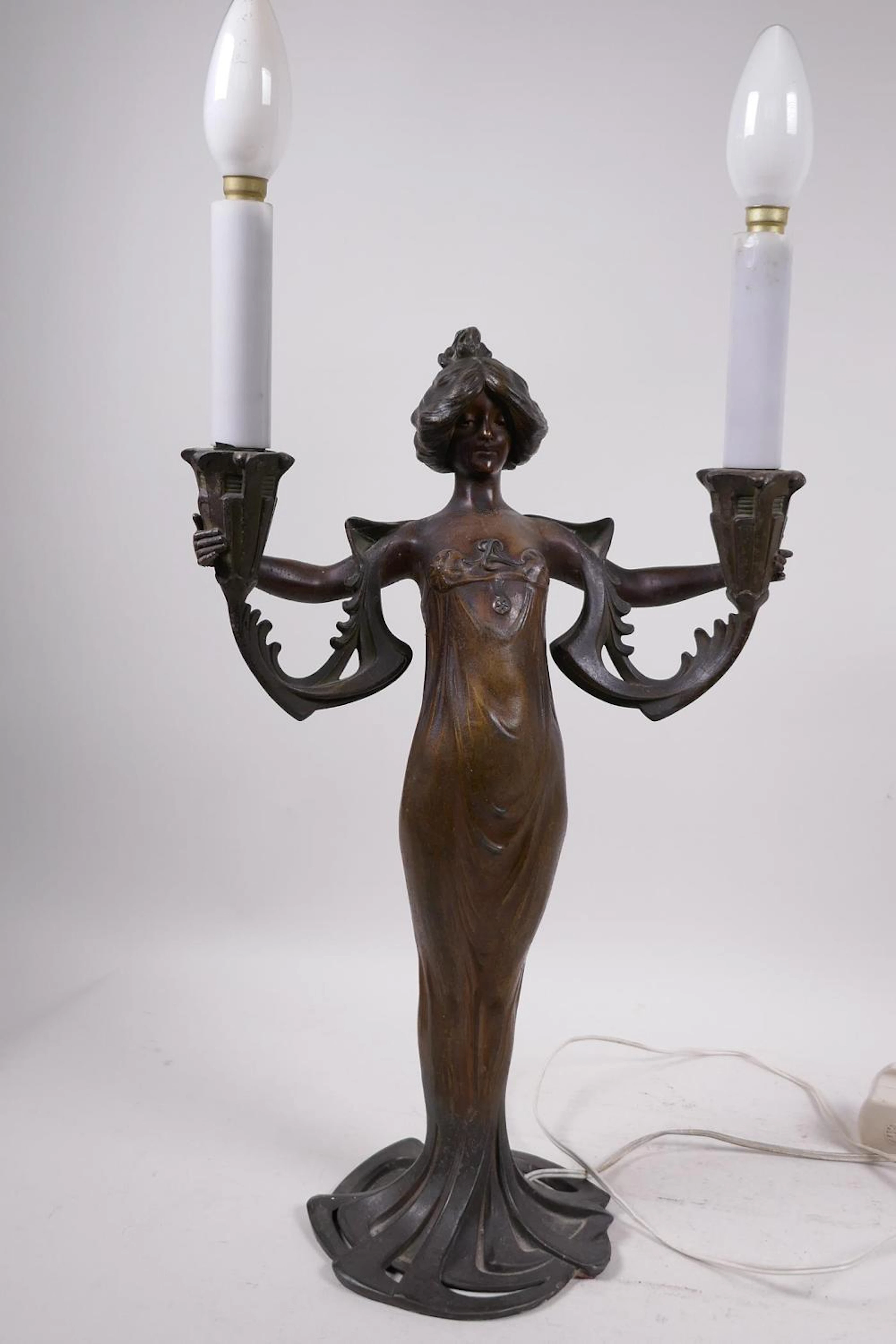 An Art Nouveau bronzed metal two light table lamp by Lucien Alliot