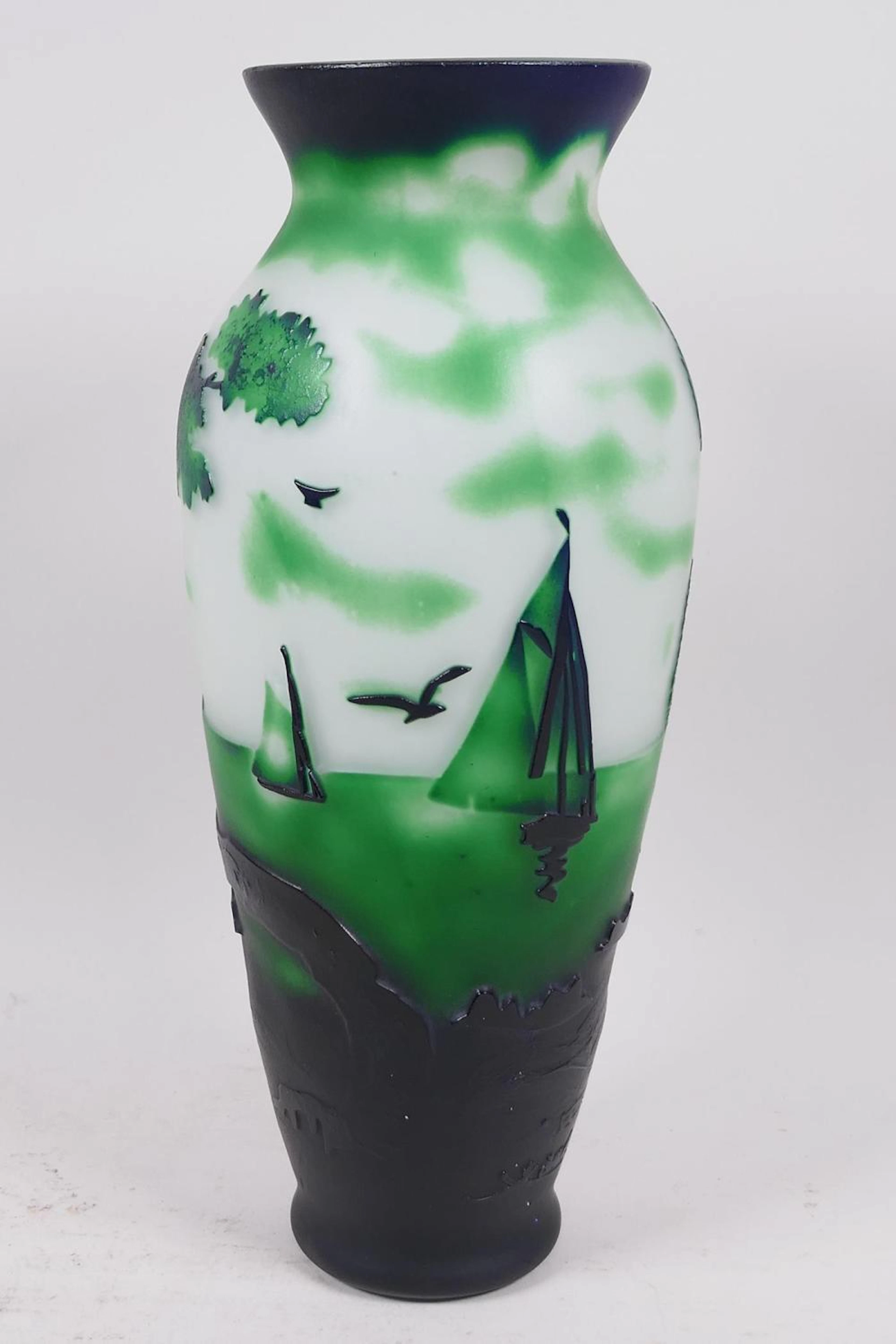 An overlaid green glass vase with decoration of sailing boats off the coast