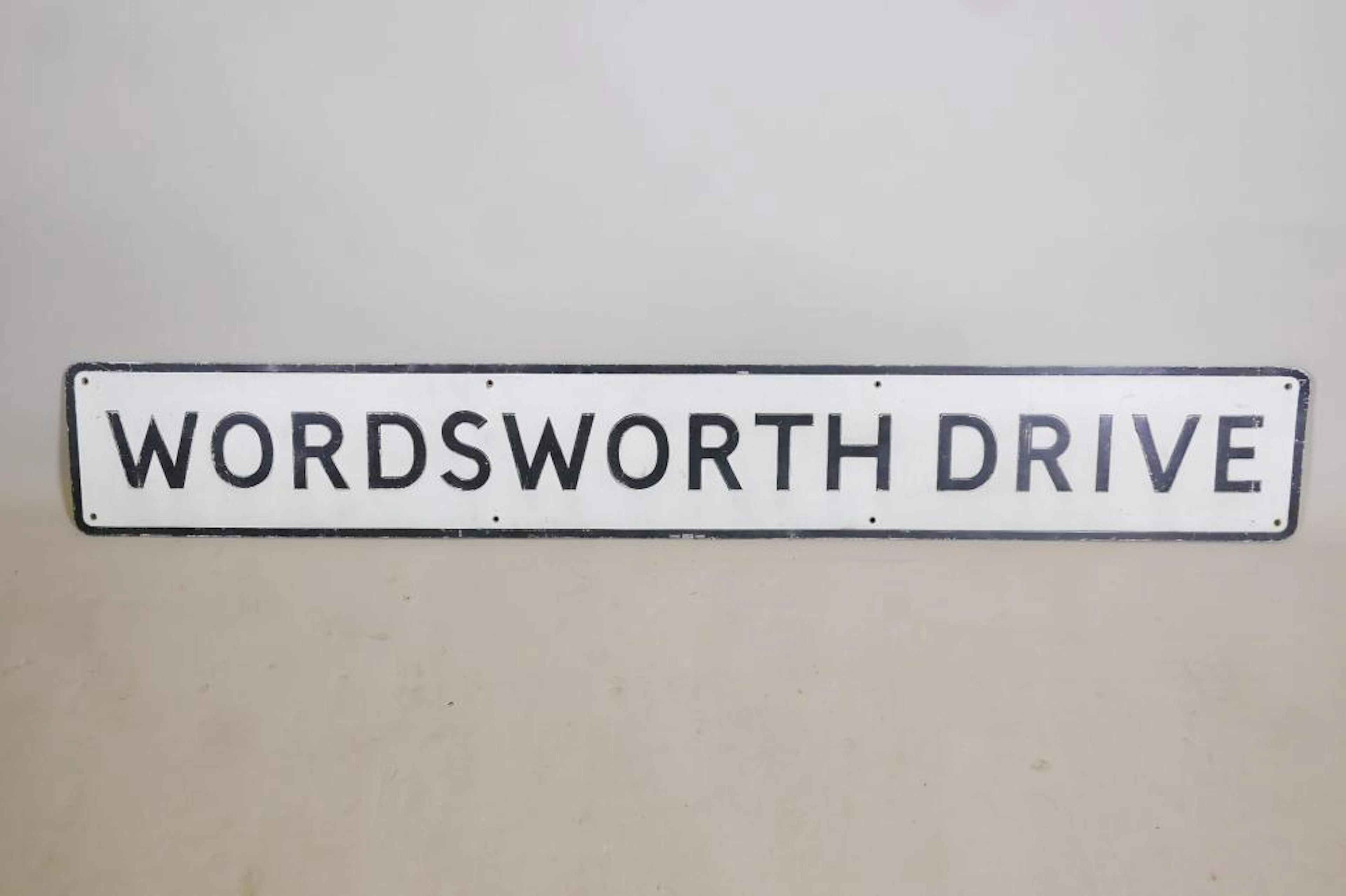A painted metal road sign, 'Wordsworth Drive', 62" x 9"