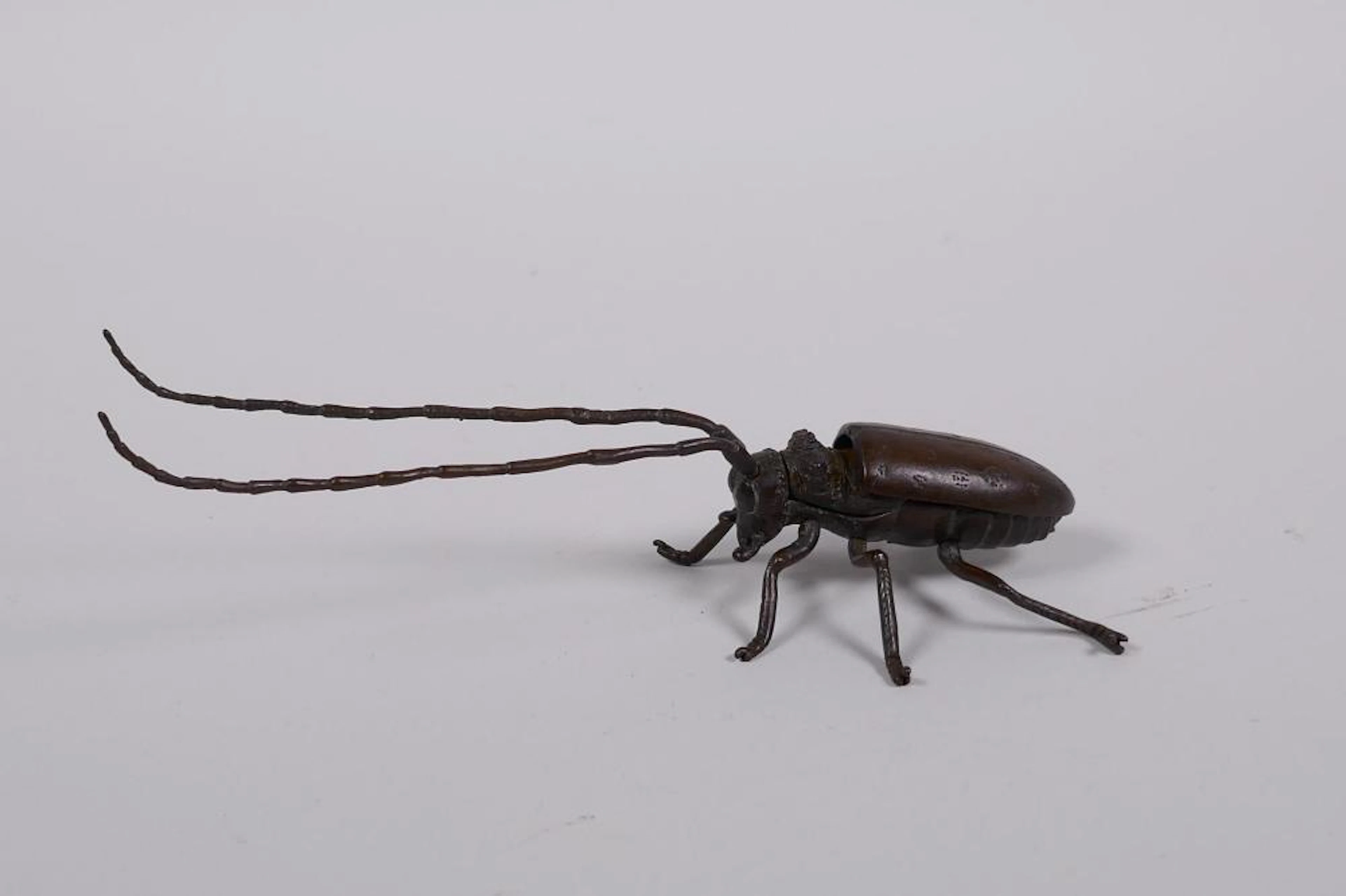 A Japanese Jizai style bronzed metal beetle with articulated limbs