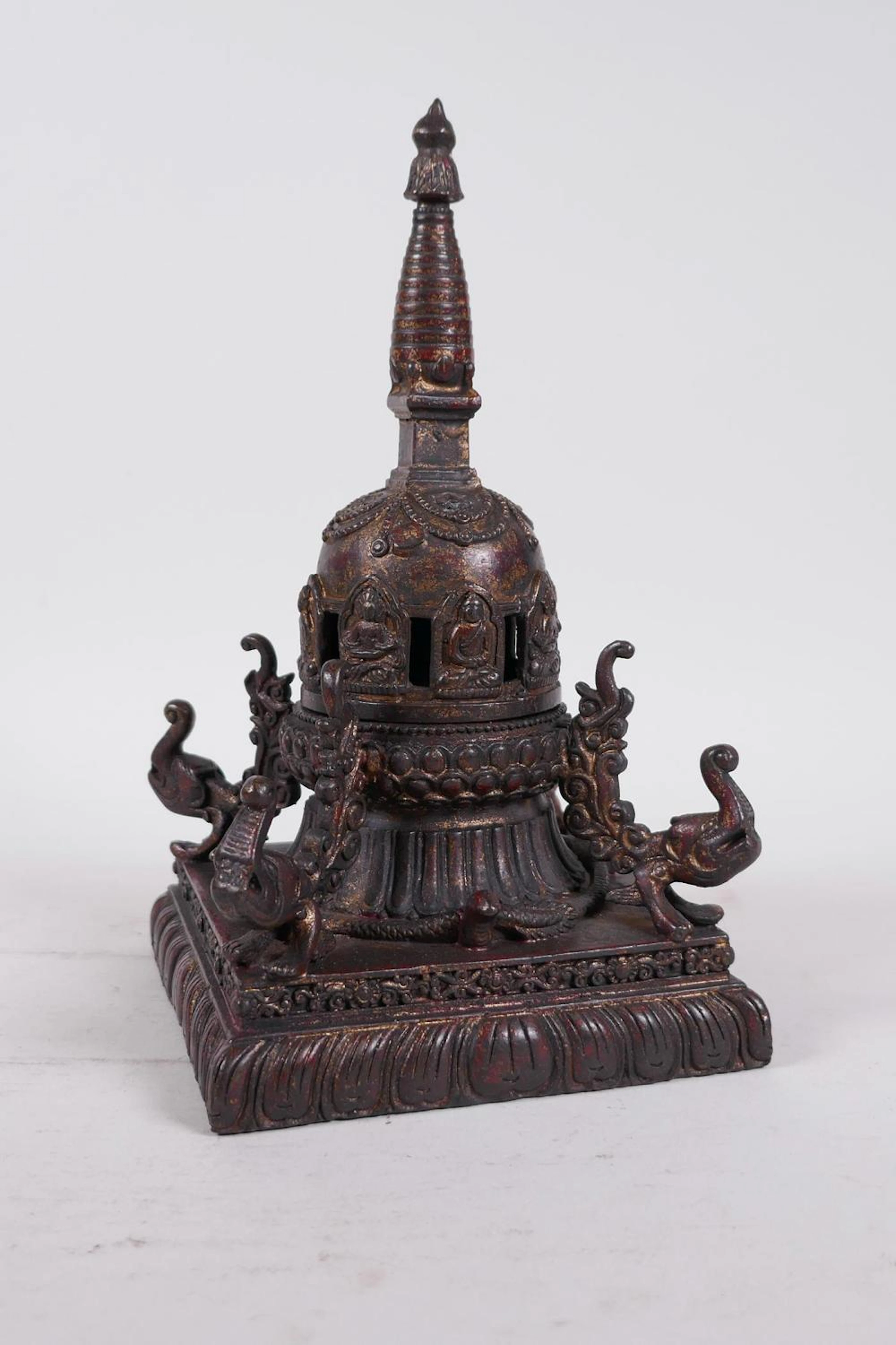 A Tibetan bronze stupa with a gilt patina