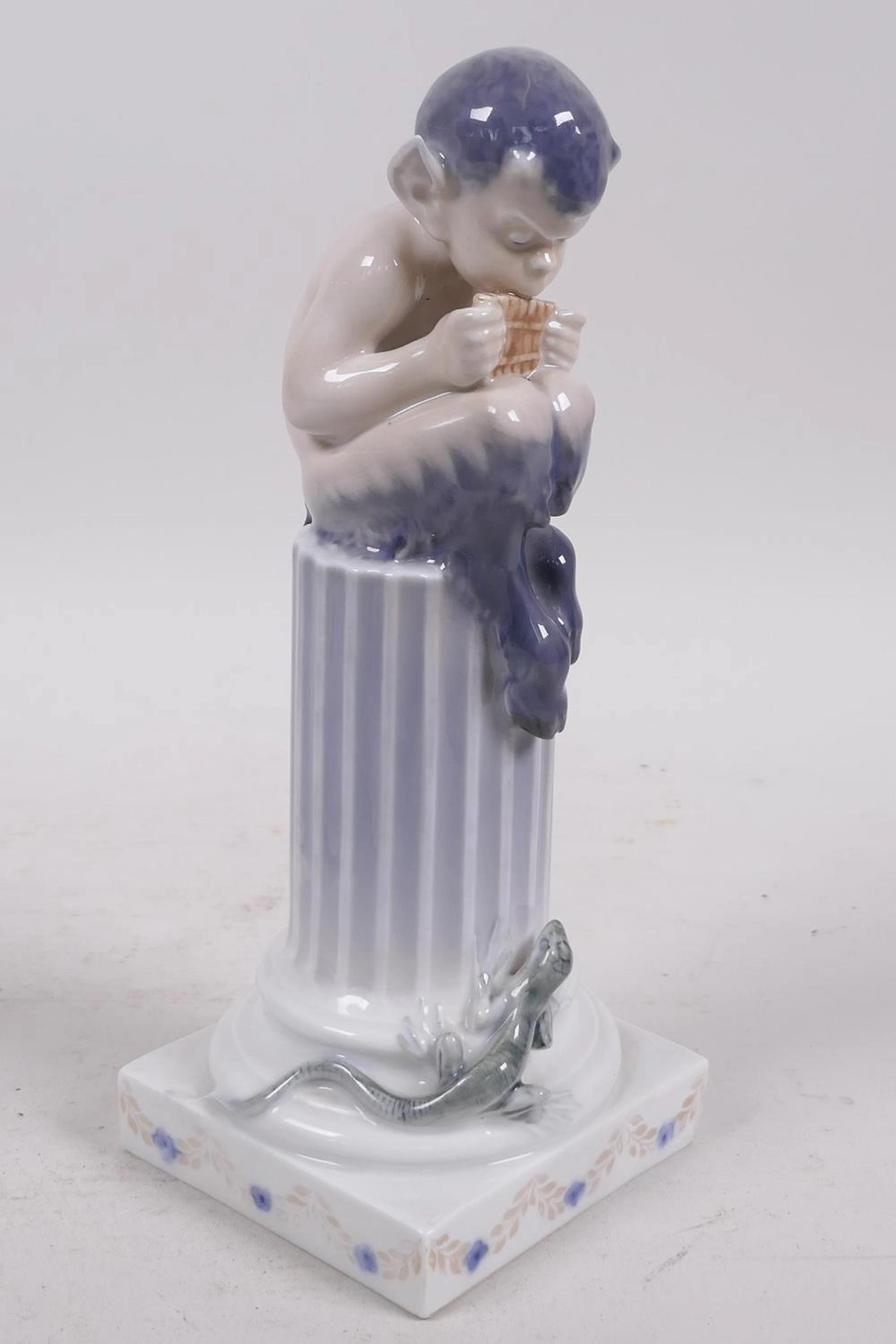 A Royal Copenhagen porcelain figurine of a young faun...