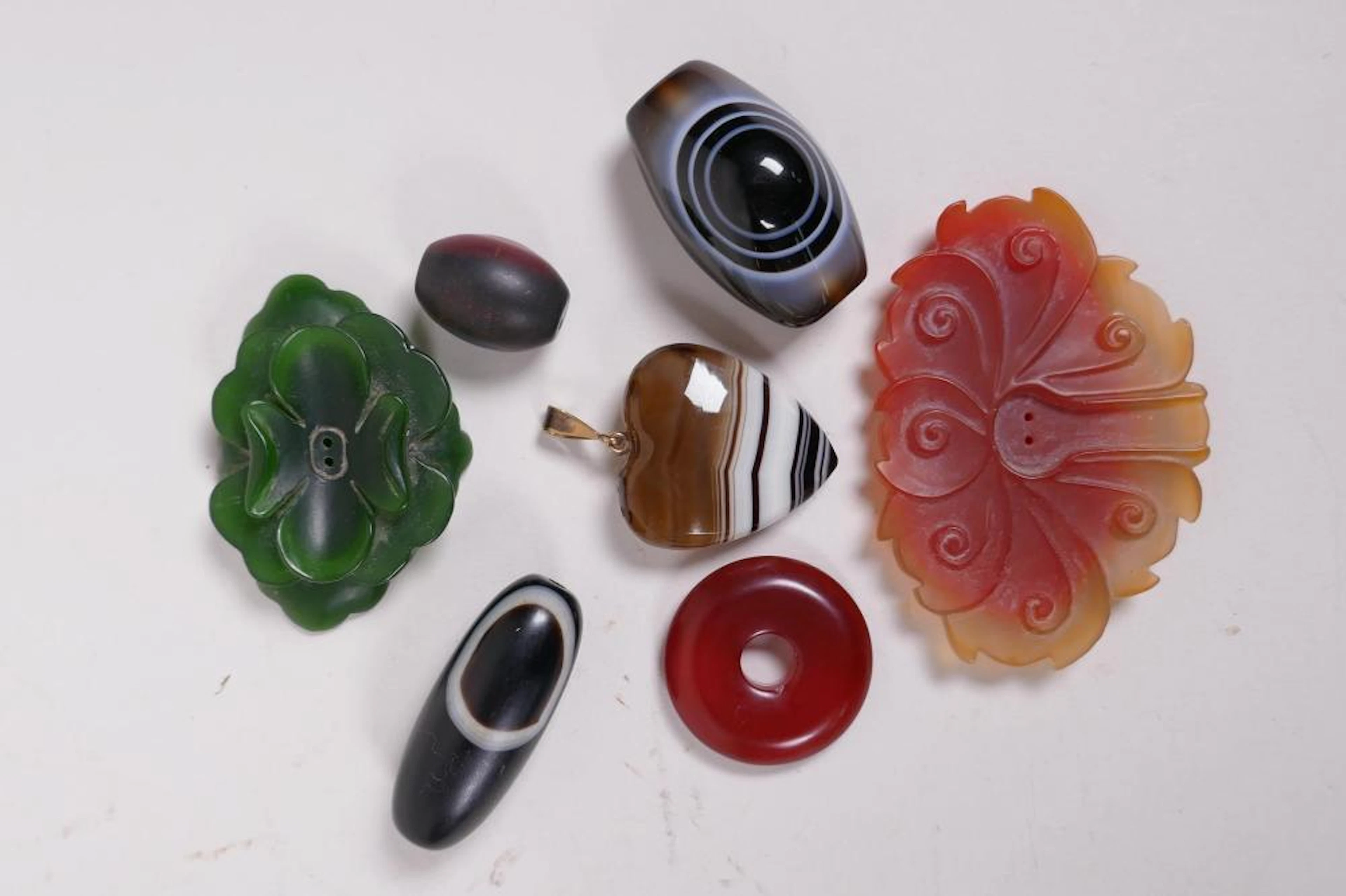 A collection of assorted agate and hardstone beads and pendants, largest 2½"