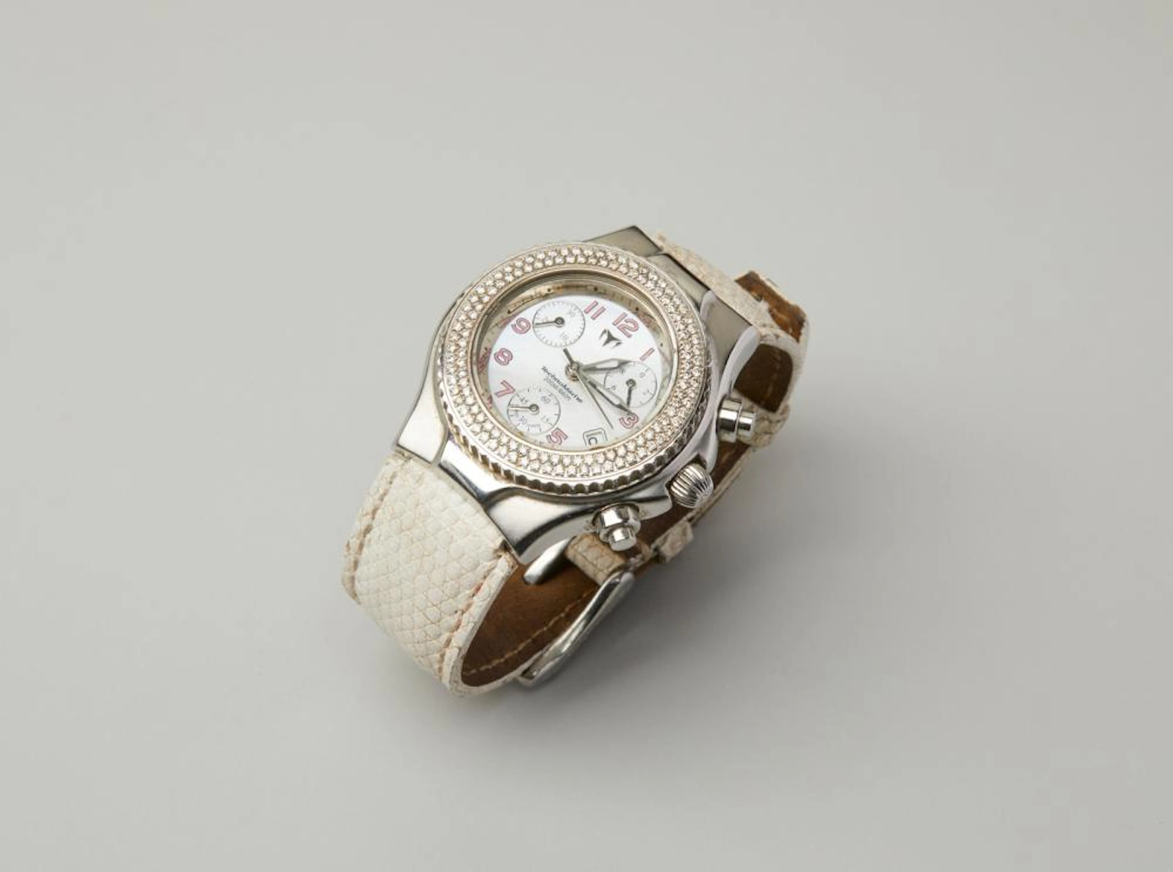 TECHNOMARINE Women steel watch with rhinestones and white faux leather band.