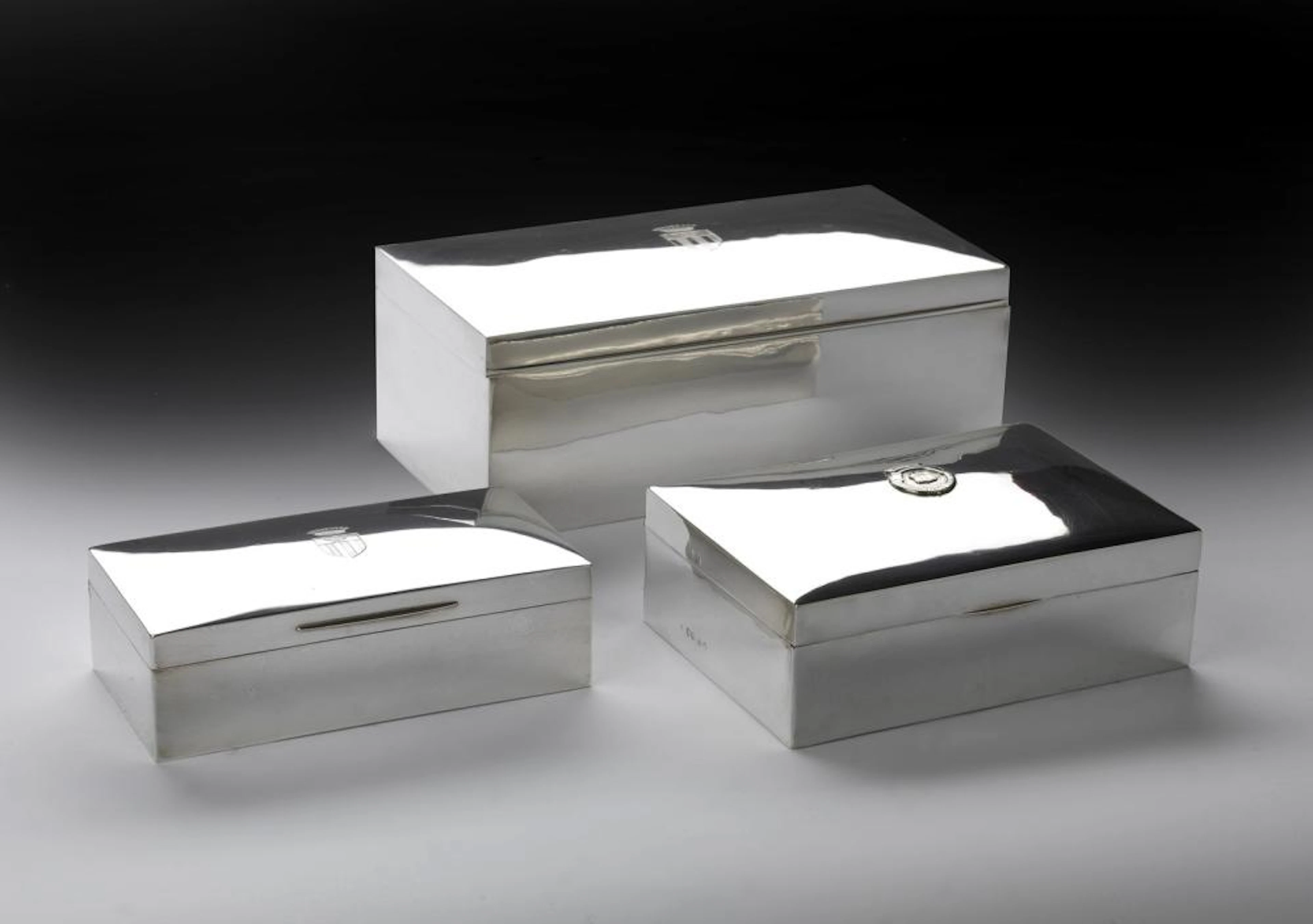 19TH-20TH CENTURY ENGLISH SILVERSMITH Three silver boxes with coat of arms.