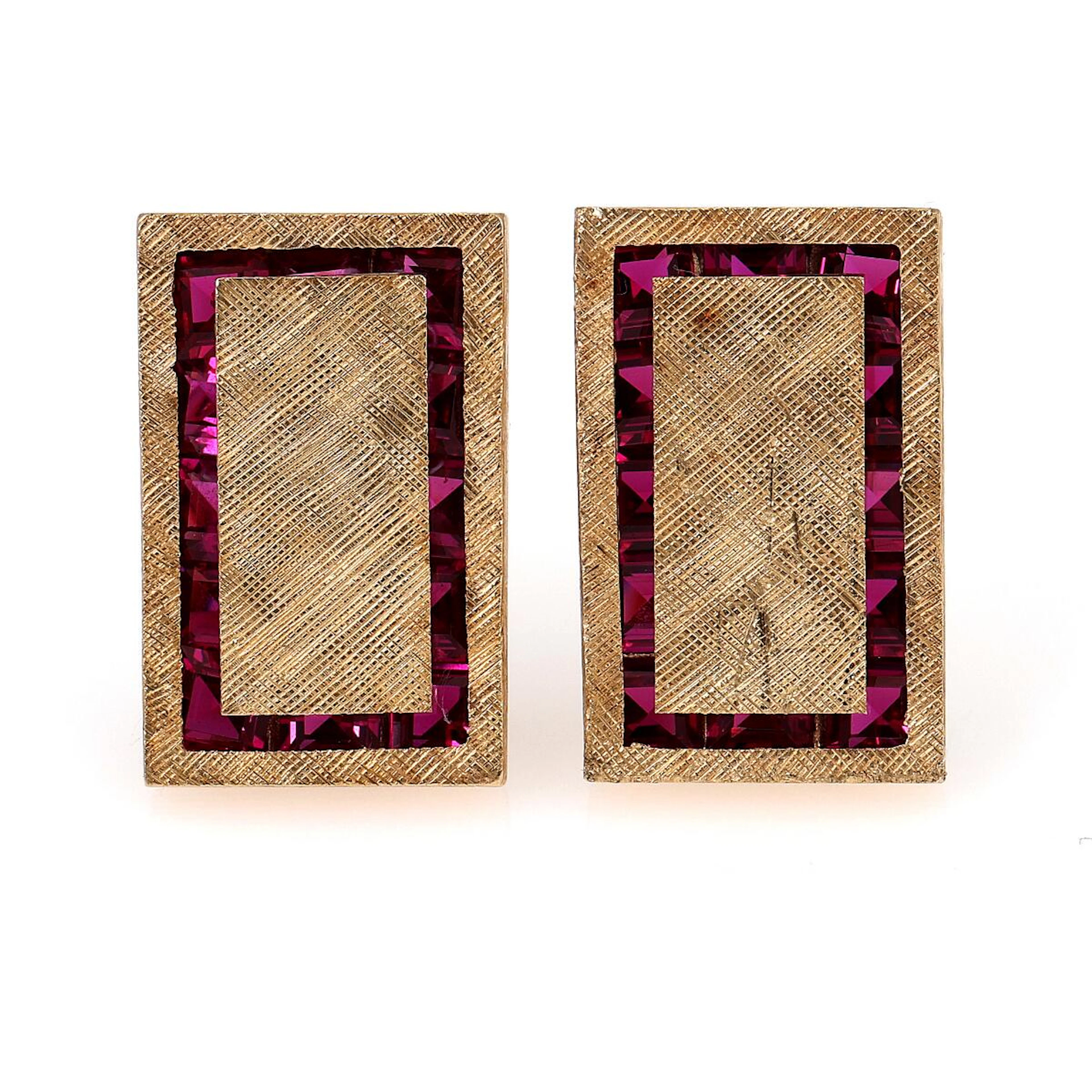 A pair of ruby ear studs each set with numerous carre-cut rubies