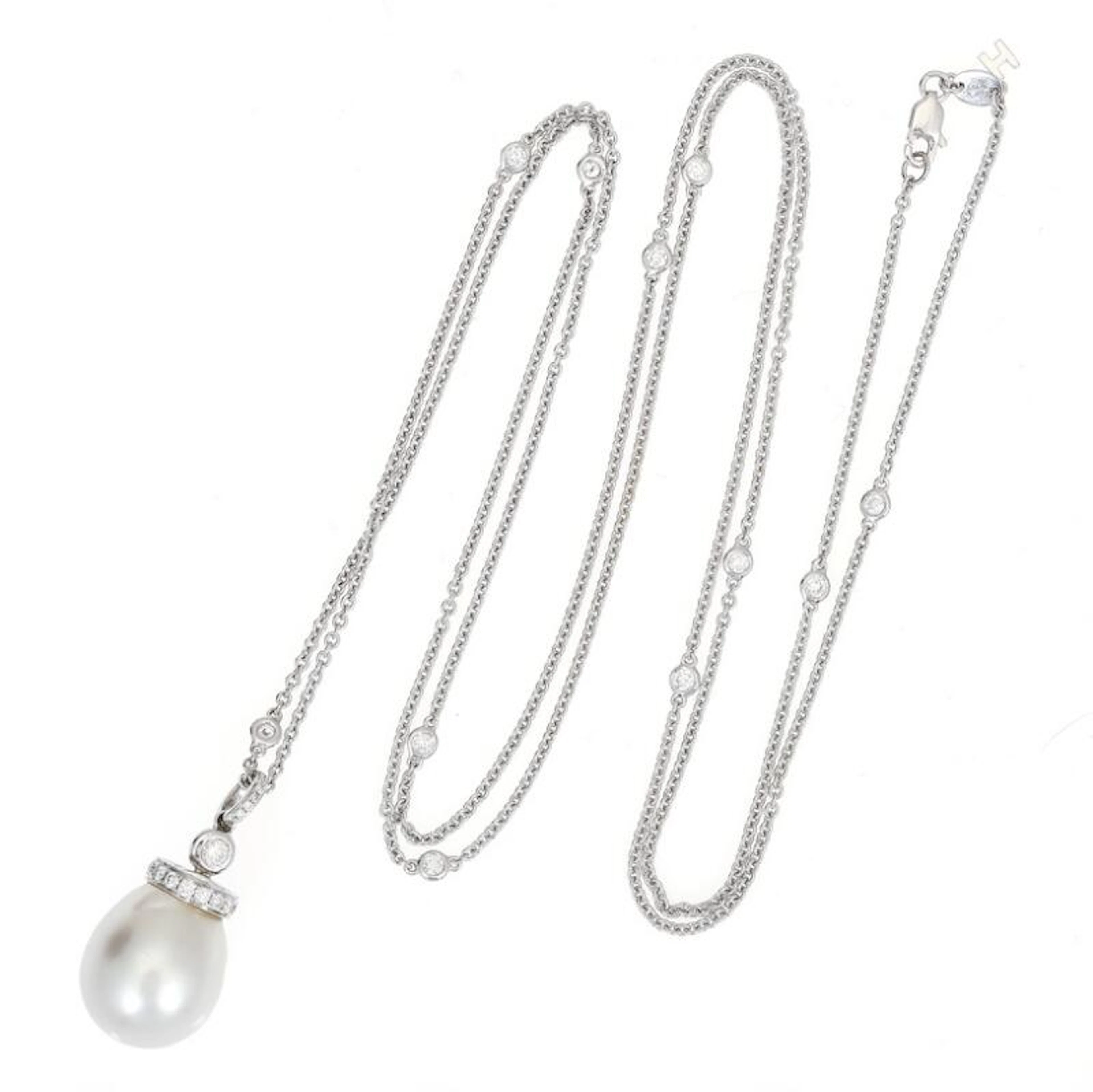 A pearl and diamond pendant set with a South Sea pearl...