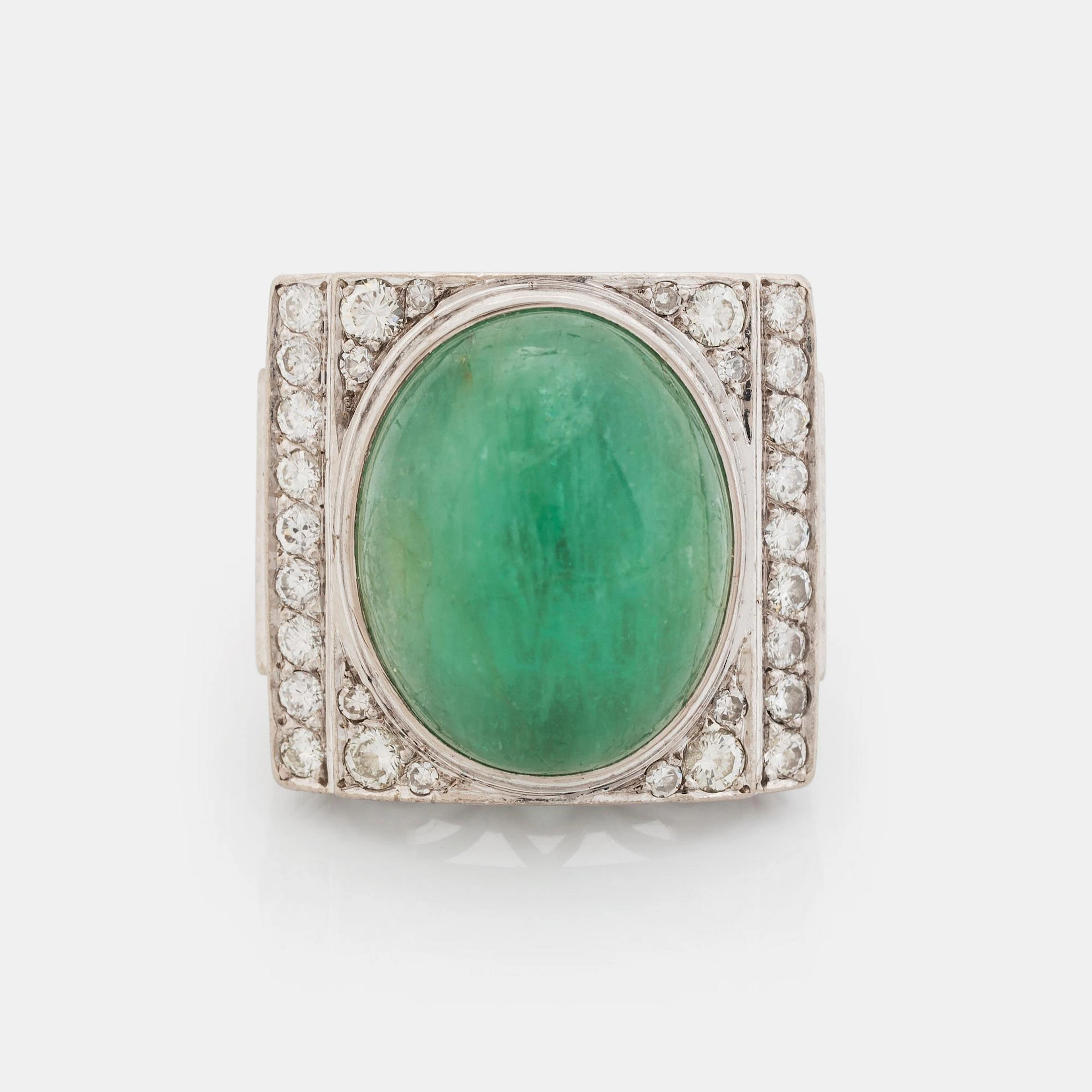 An 18K white gold ring set with a cabochon-cut emerald...