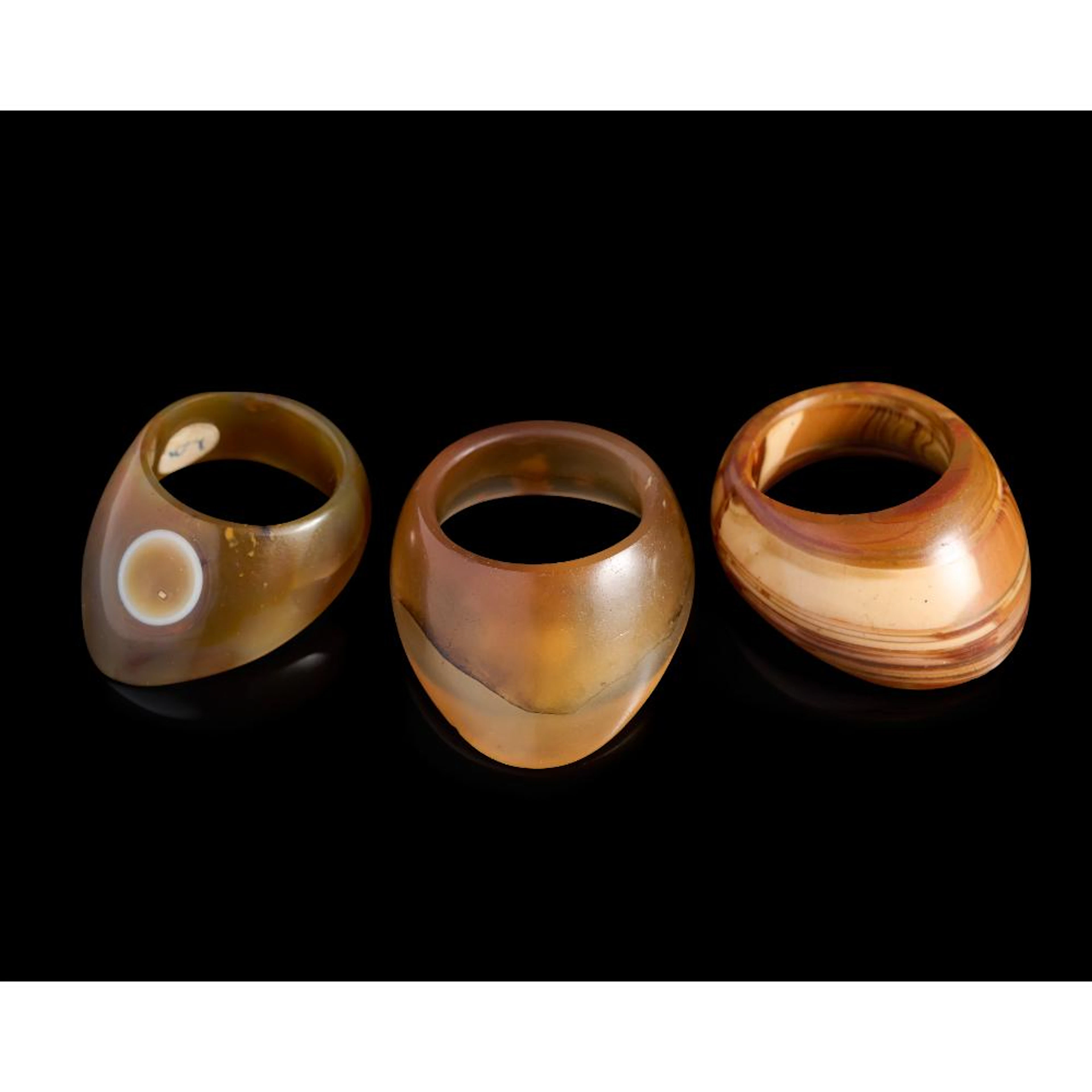 THREE INDIAN HARDSTONE ARCHER'S RINGS, 17TH/18TH CENTURY