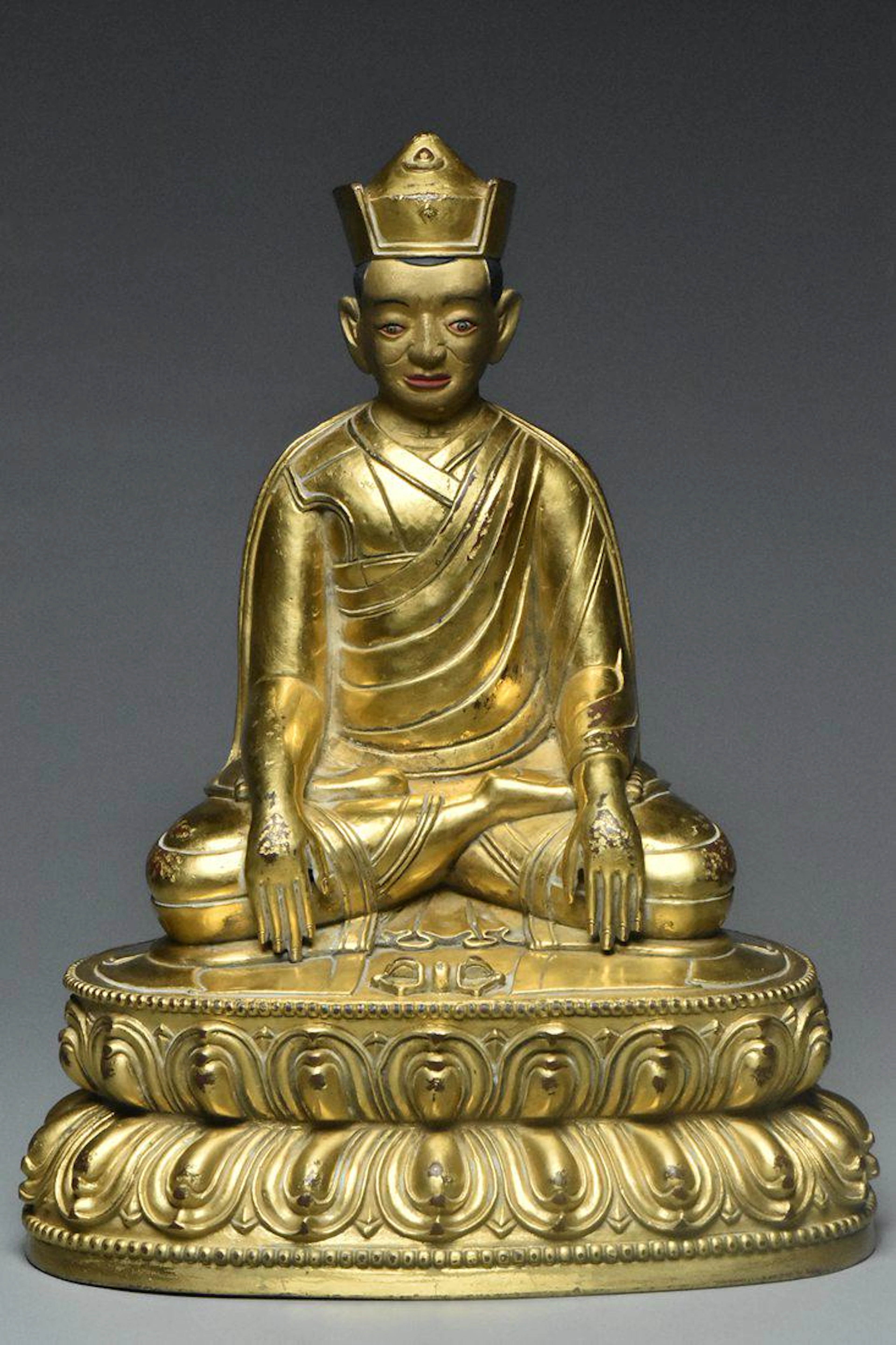A qing dynasty gilt bronze figure of lama