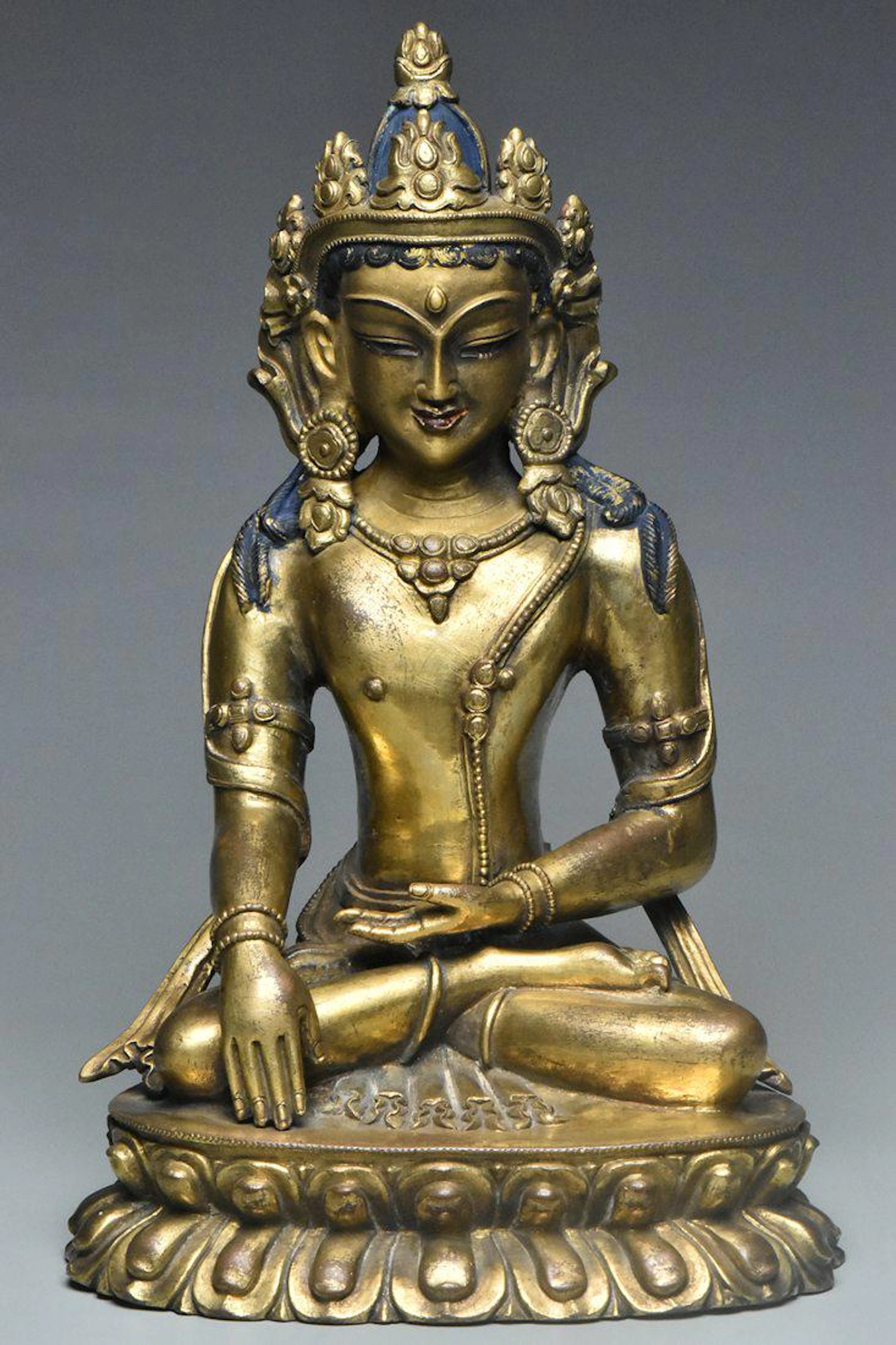A qing dynasty gilt bronze figure of amitayus
