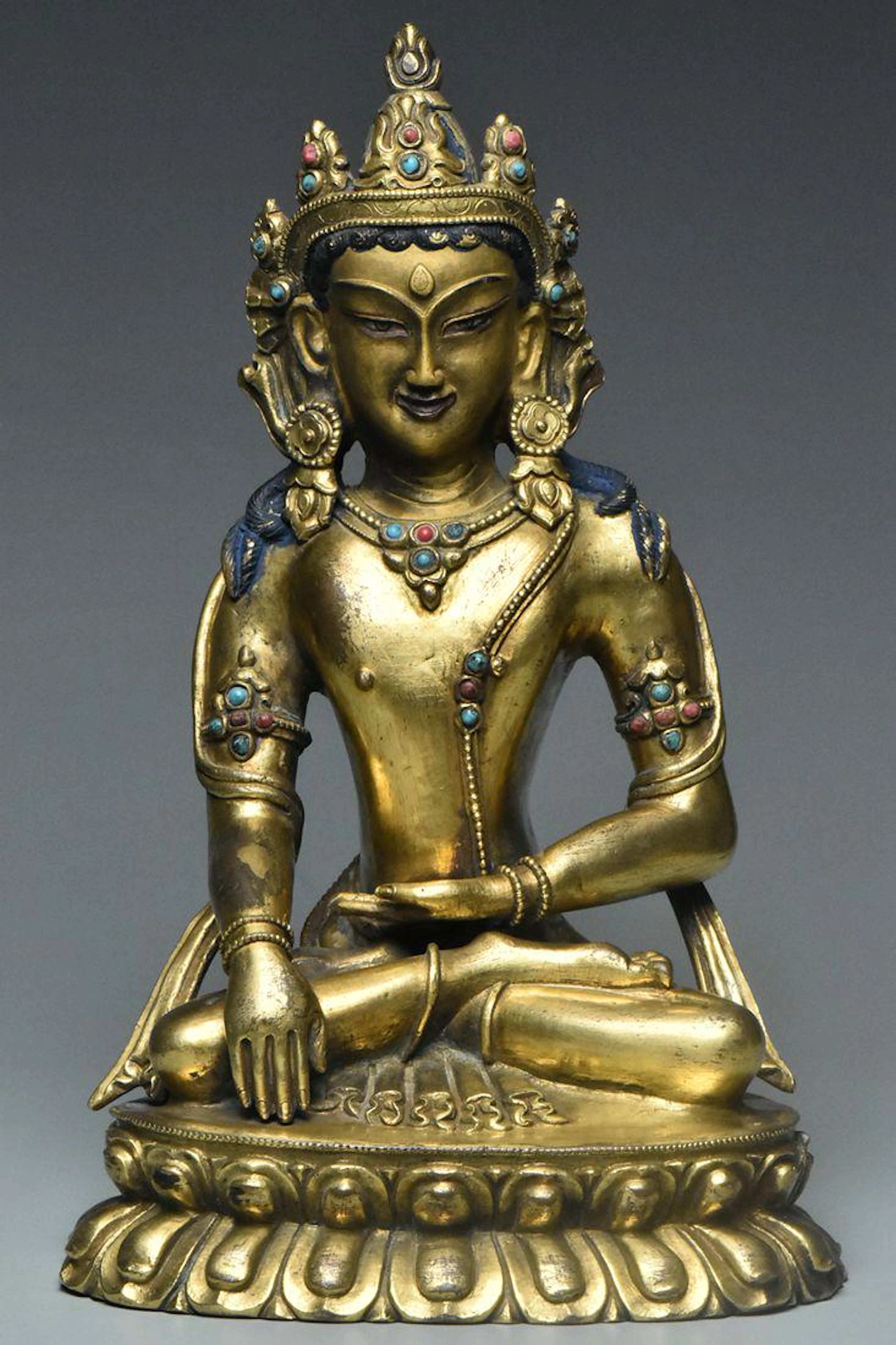 A qing dynasty gilt bronze figure of amitayus