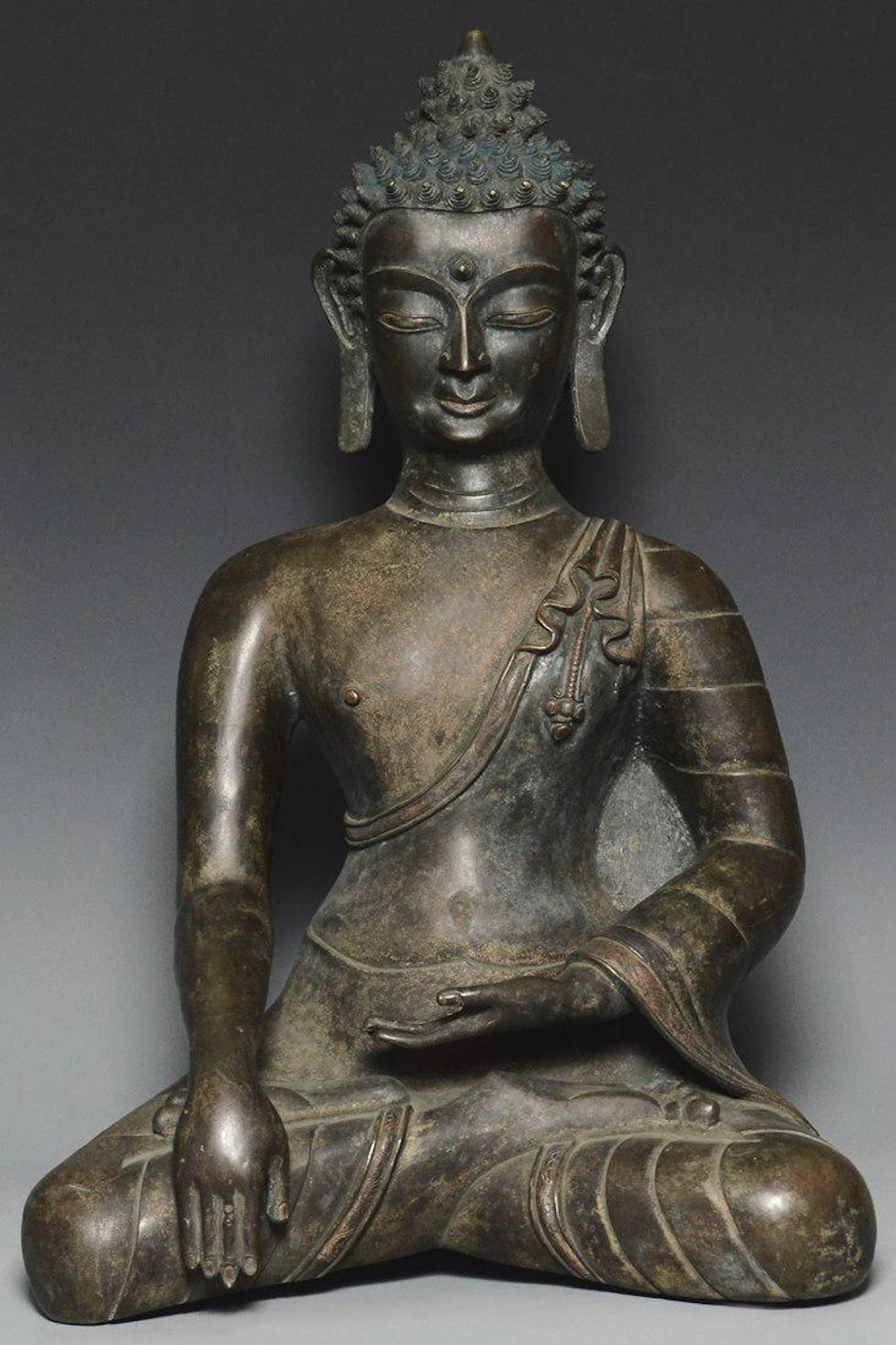A large yuan dynasty bronze figure of buddha