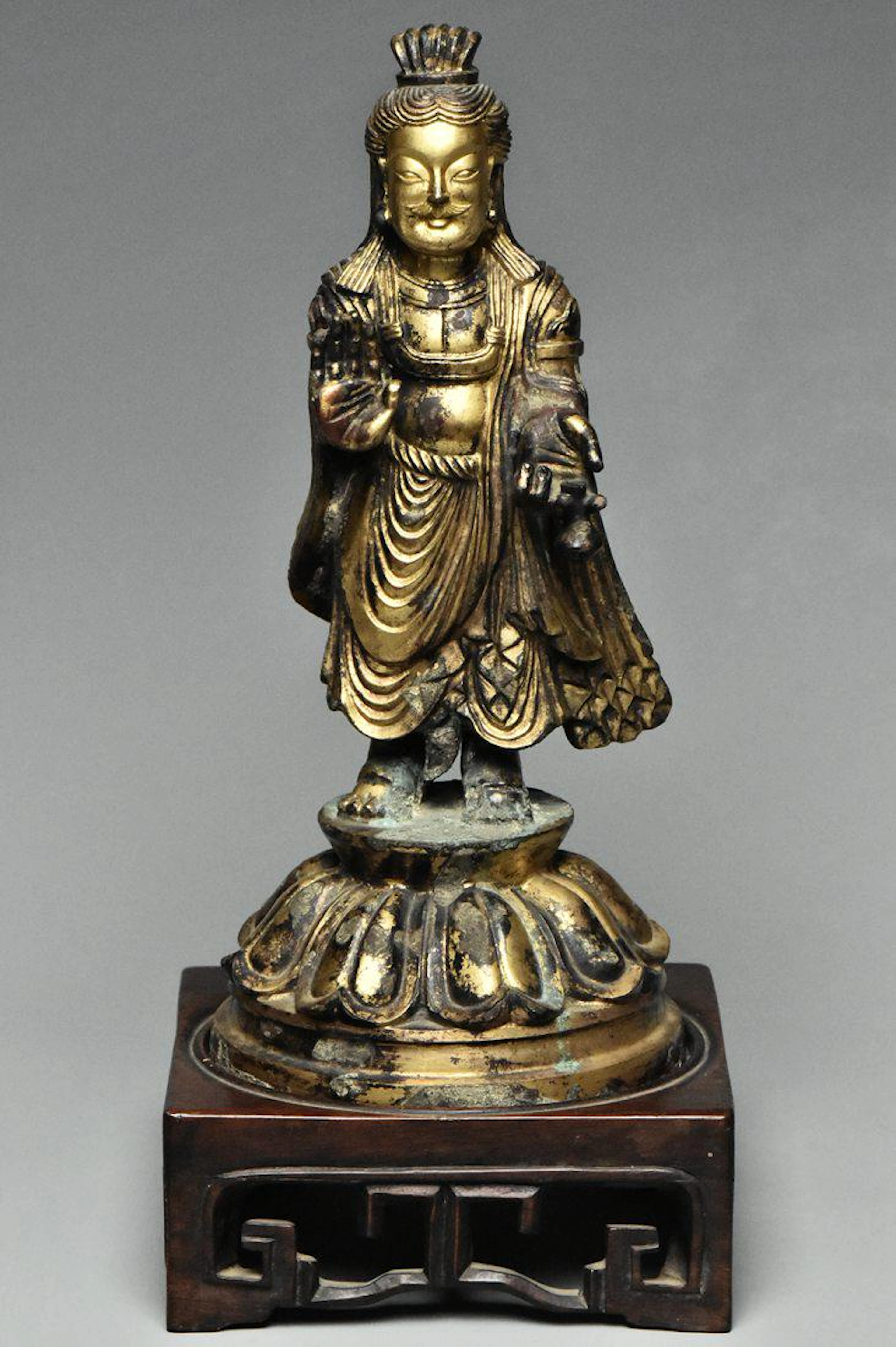 A tang dynasty gilt bronze buddha and stand