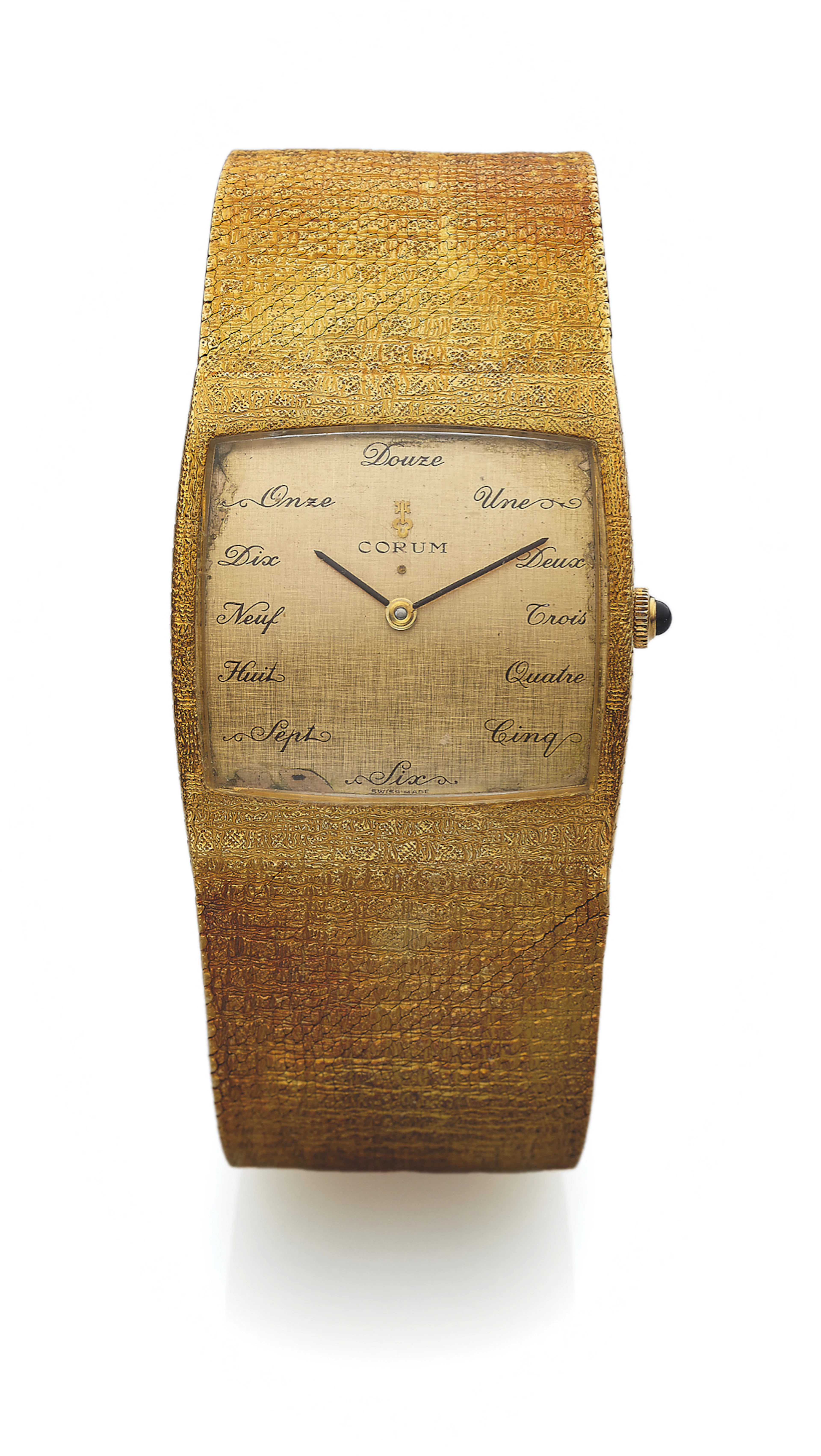 CORUM REF. 8989 SPARTACUS YELLOW GOLD Corum, Spartacus, Ref. 8989. Made in the 1970s. Very fine, large, cushion-shaped, self-winding, 18K yellow gold wristwatch with an integral 18K yellow gold textur