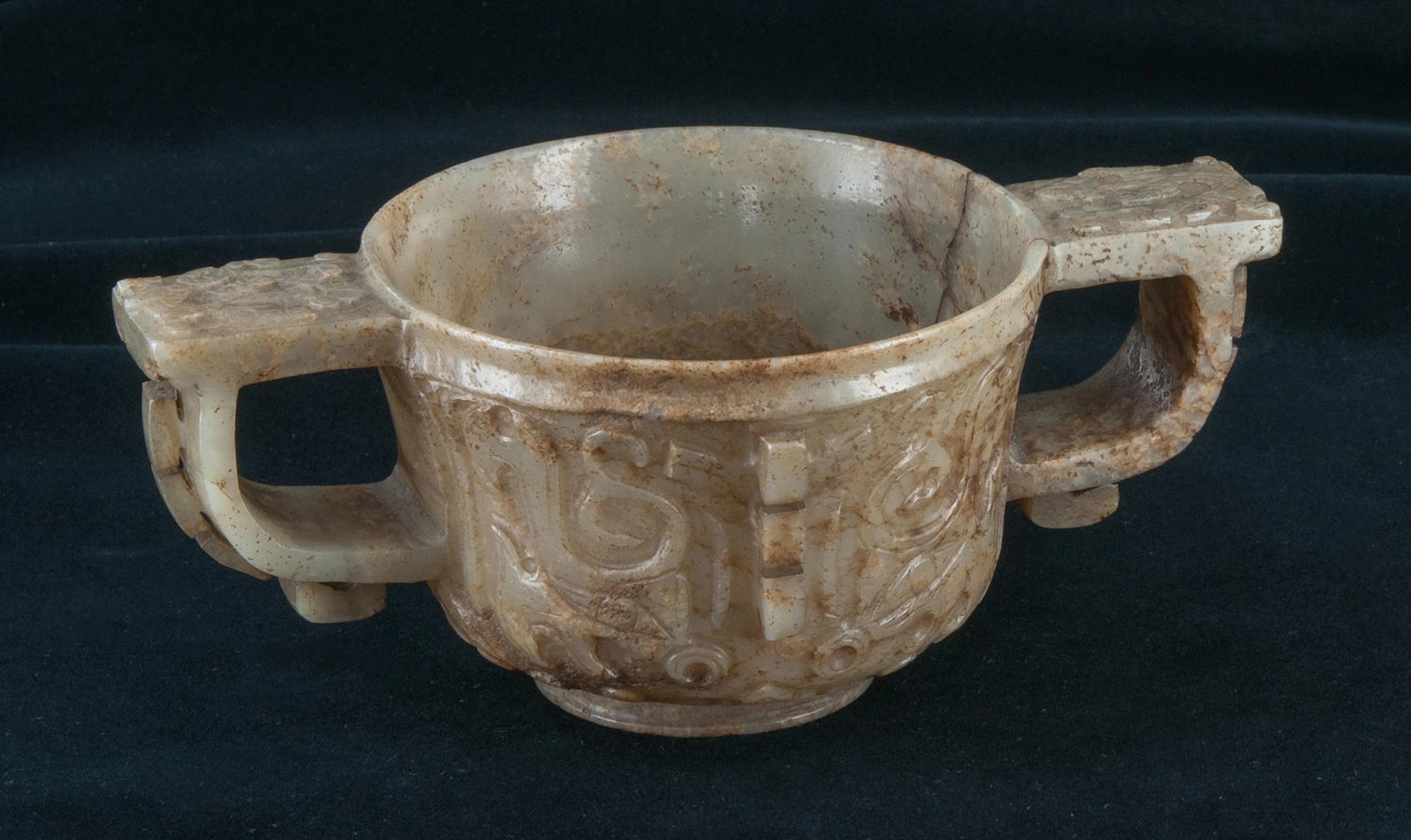 A rare interesting two-handled white jade cup