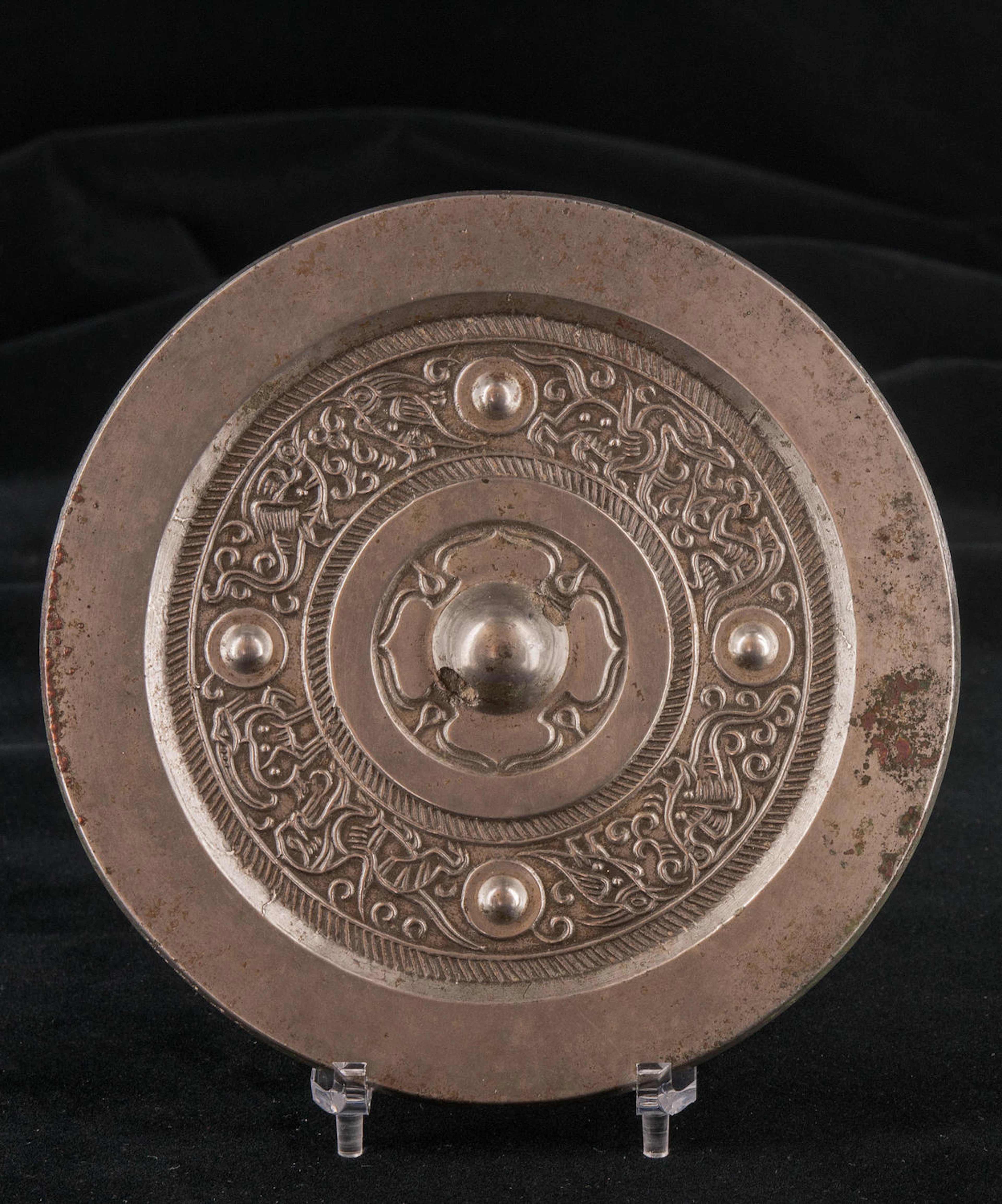An exceptionally fine bronze circular mirror with silvery shine