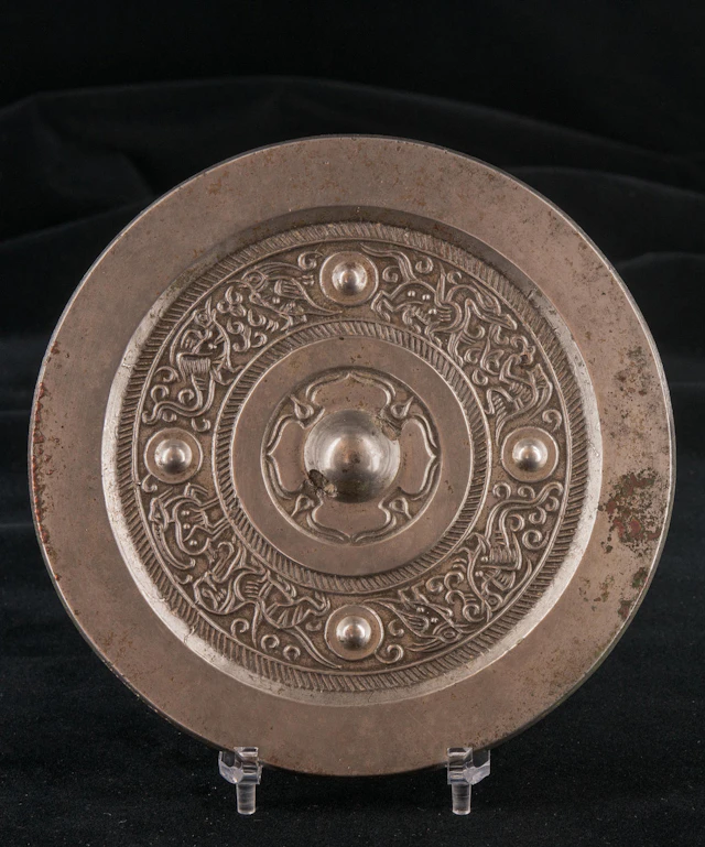 An exceptionally fine bronze circular mirror with silvery shine
