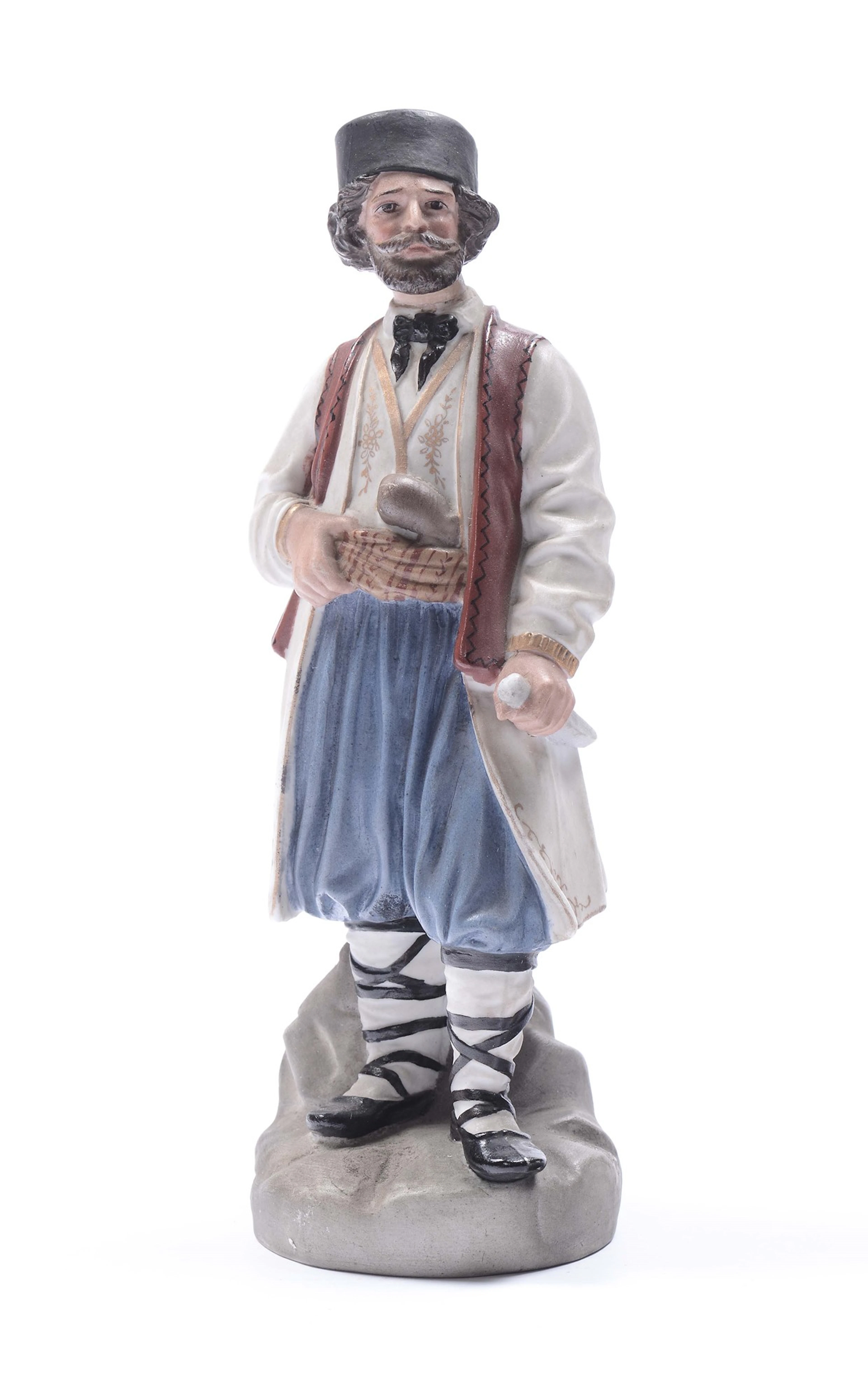 Rara statuina in biscuit policromo raffigurante figura in costume