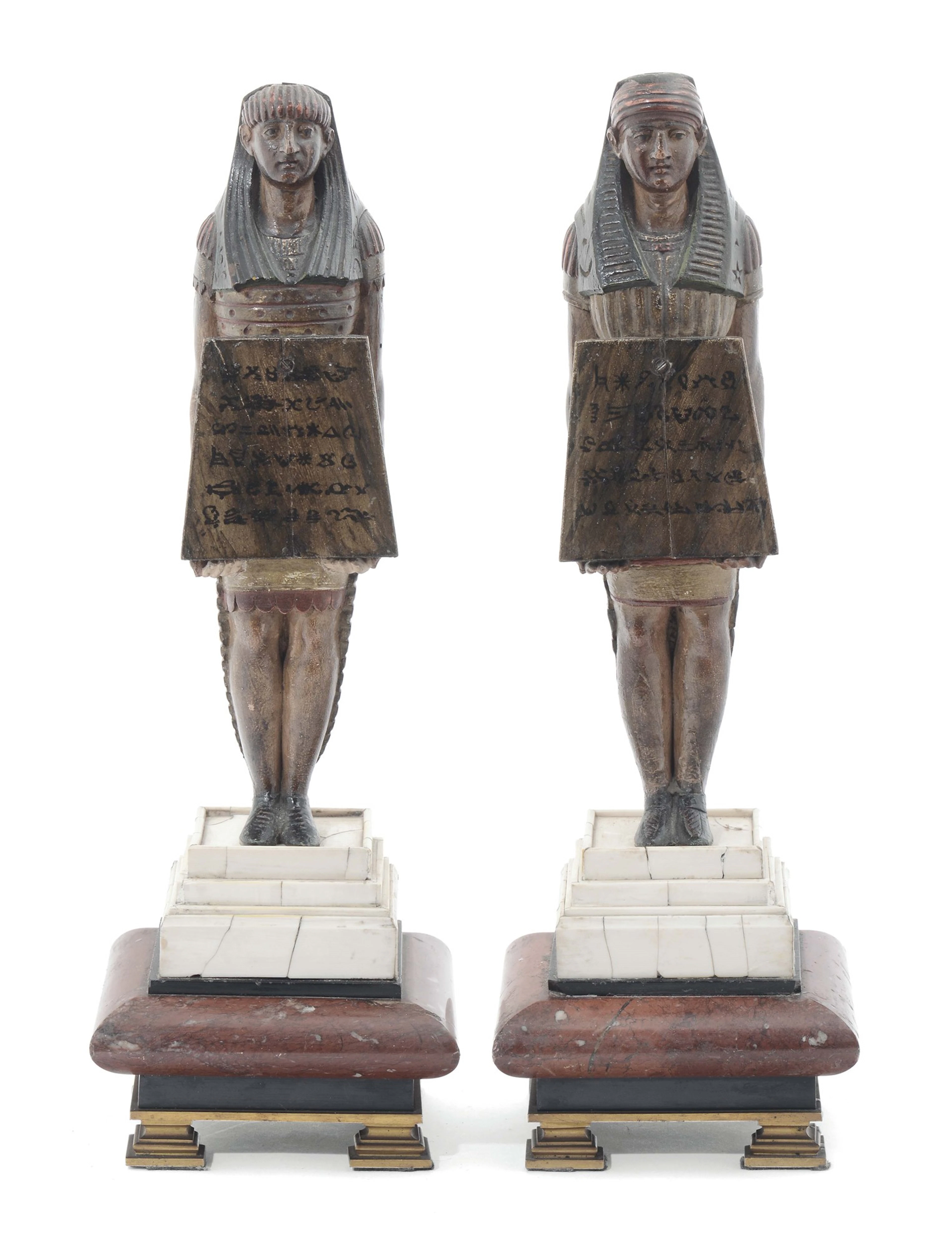 A pair of Egyptian figures in painted wood on marble and ivory bases