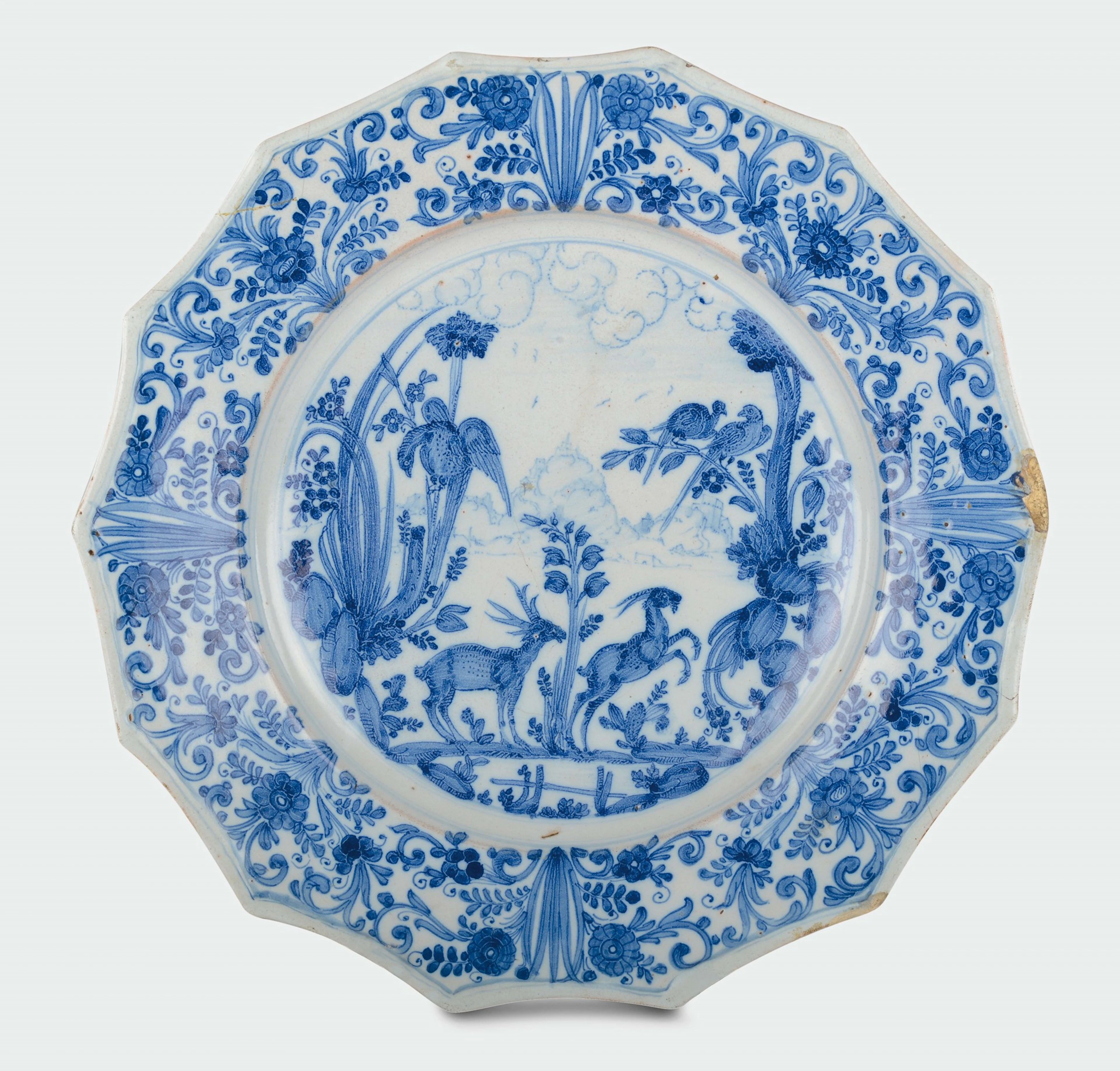 A white and blue majolica plate with �naturalistic calligraphic� decoration