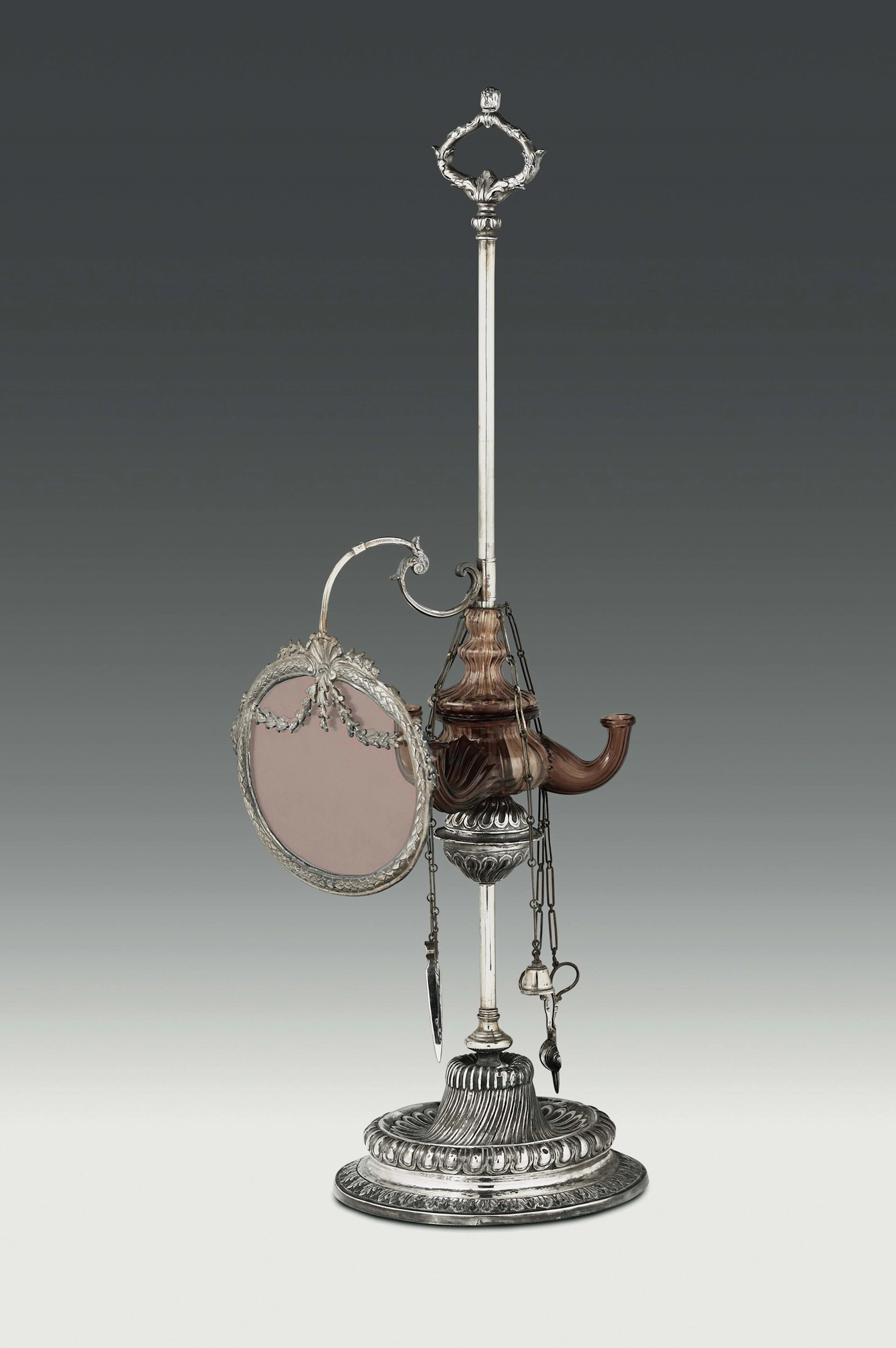 An oil lamp in embossed, molten and chiselled silver and blown glass