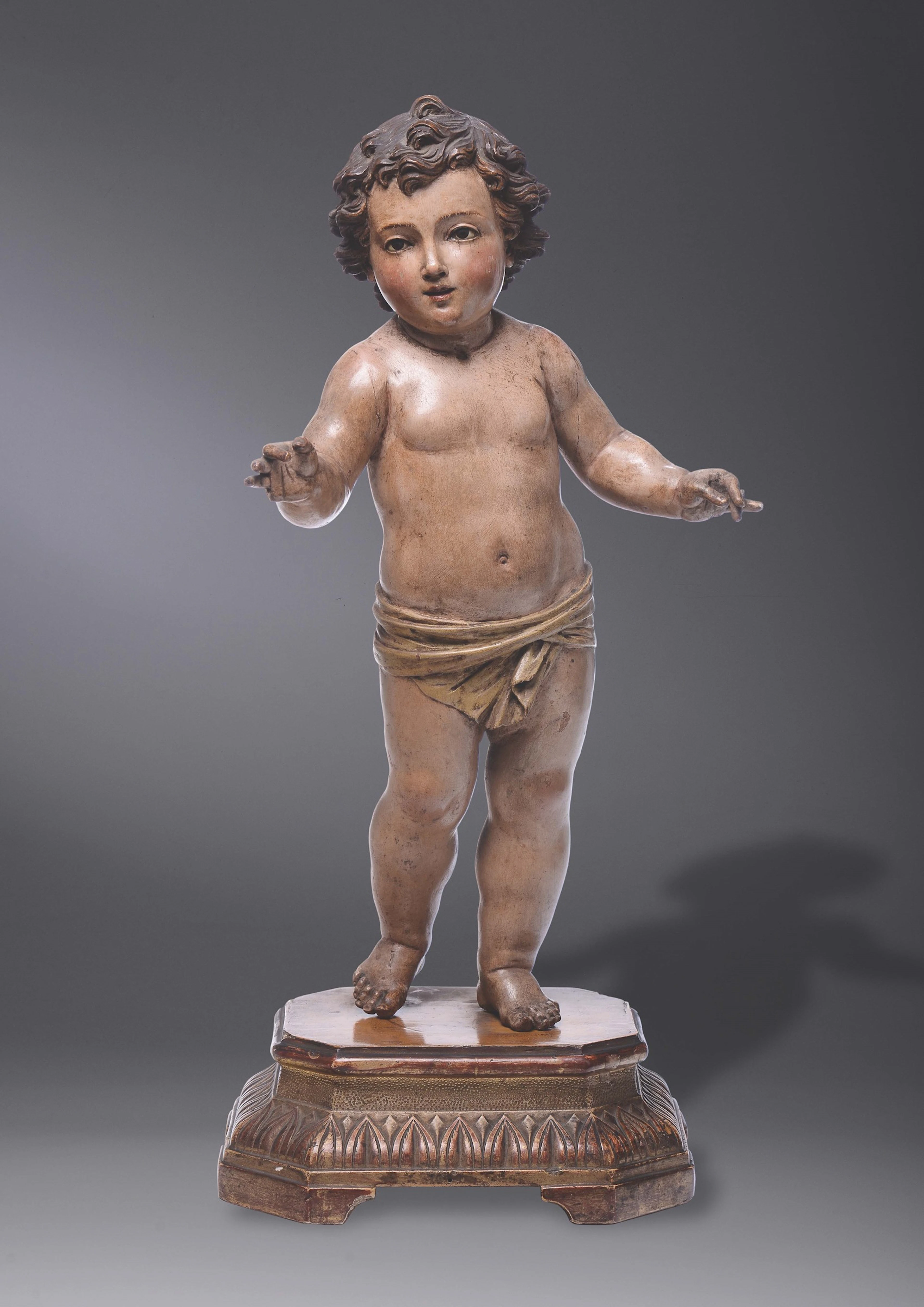 A golden, wooden polychrome sculture with baby Jesus. Second half