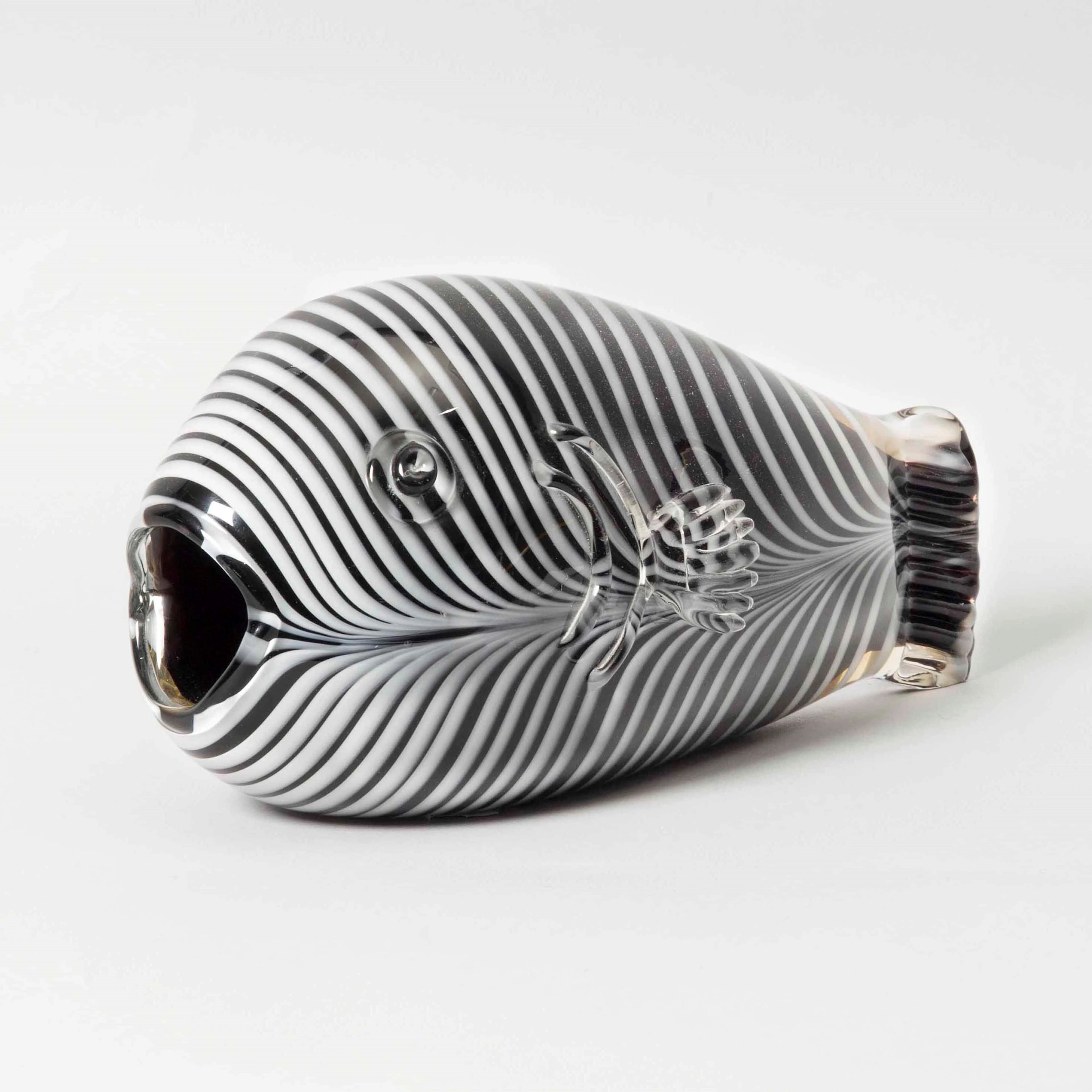 An exceptional fish in Phoenician glass on a cyclamen background with