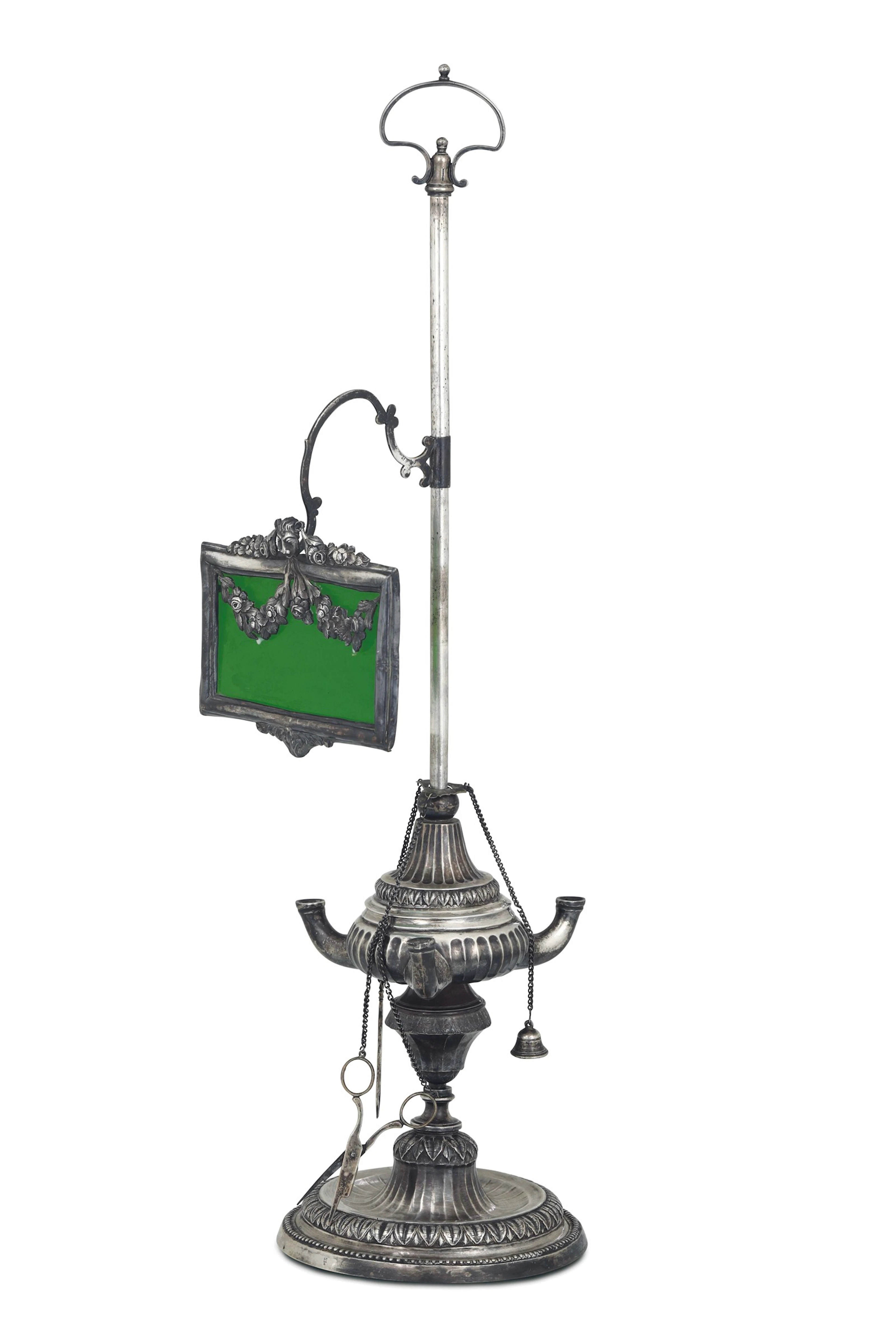 An oil lamp in molten, embossed and chiselled silver and glass. Genoa