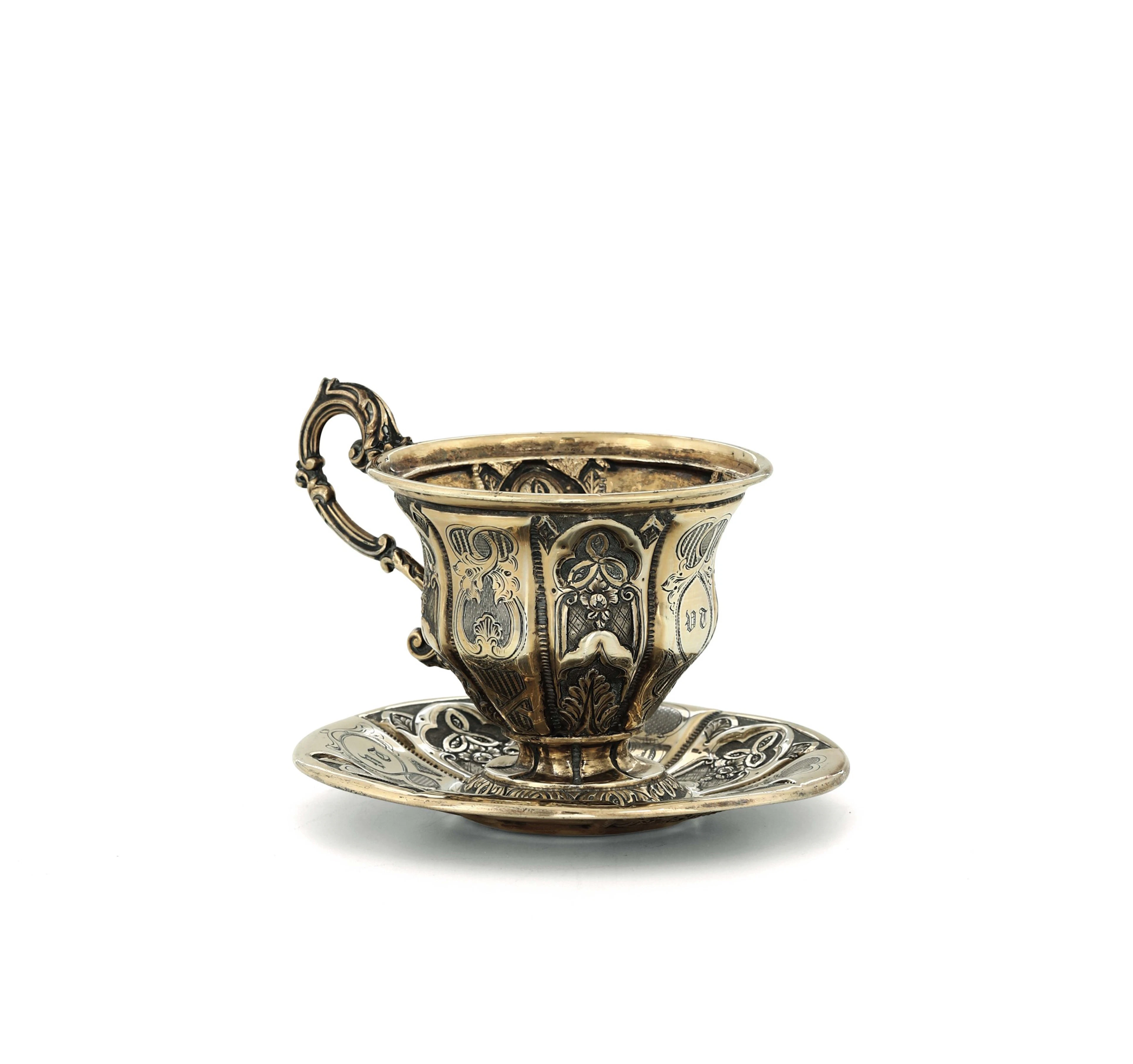 A cup and plate in first title vermeil silver, embossed and chiselled