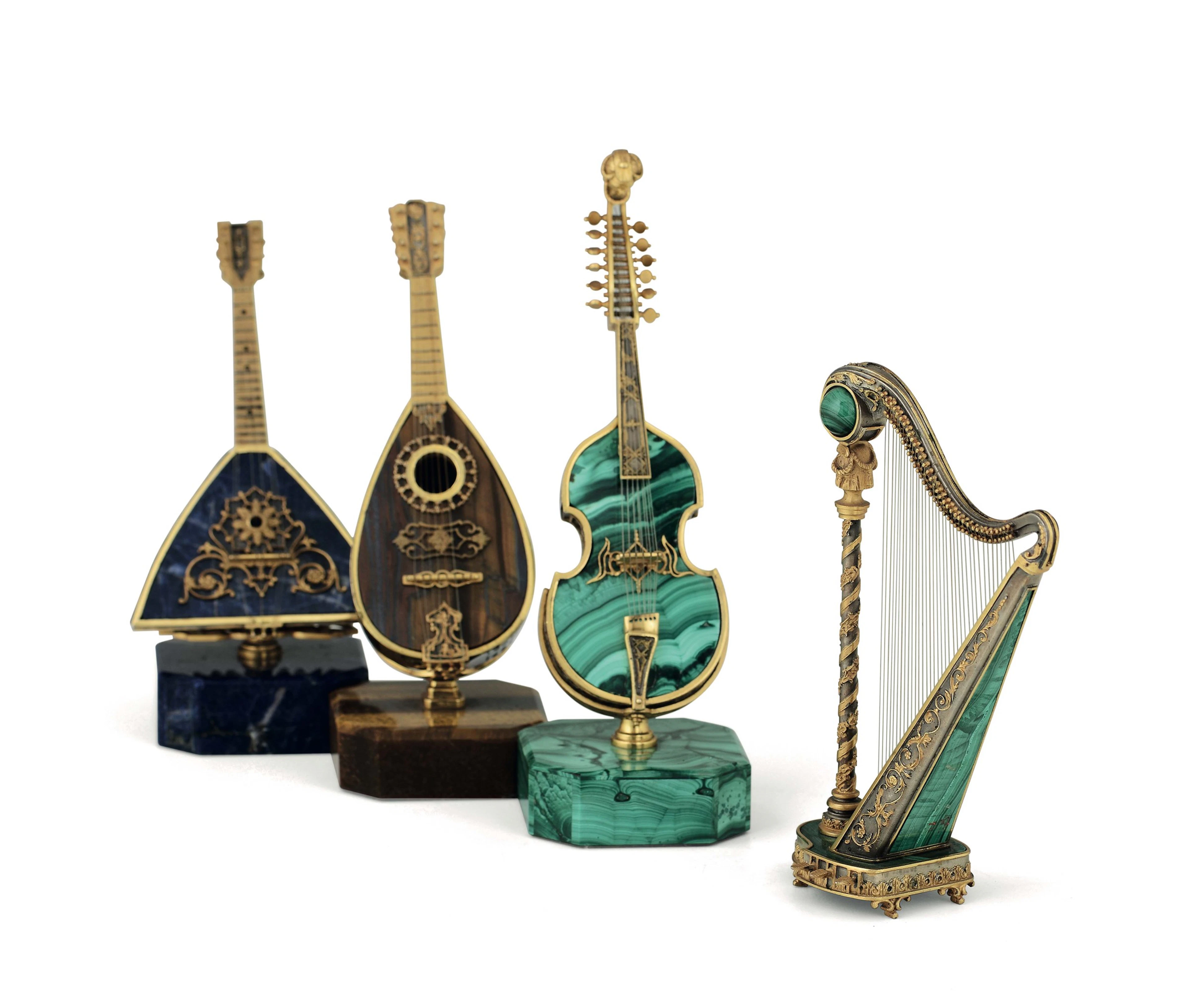 A group of four miniature musical instruments. Milanese goldsmithry
