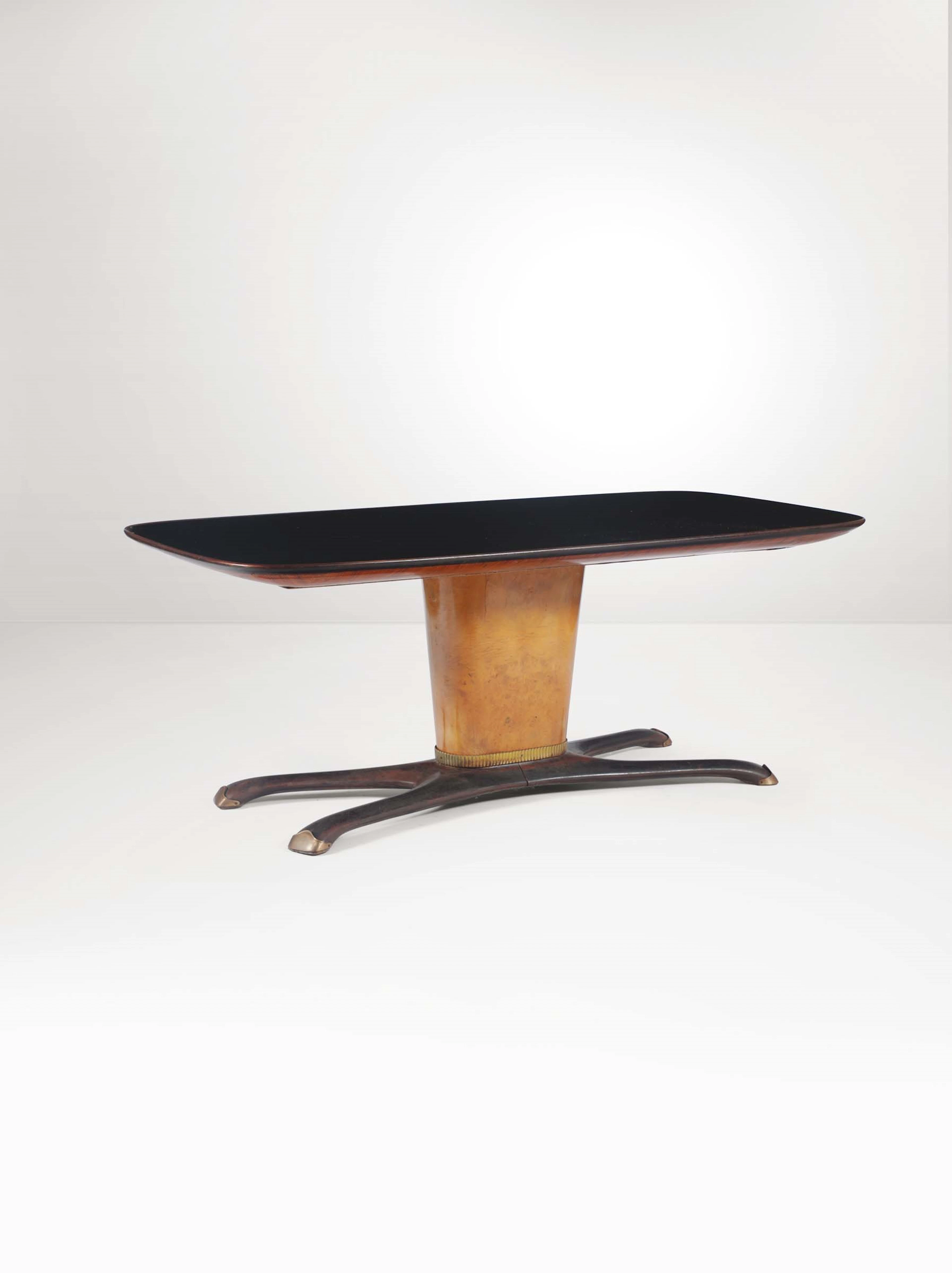 Tavolo con struttura in legno, piano in vetro e dettagli in ottone.