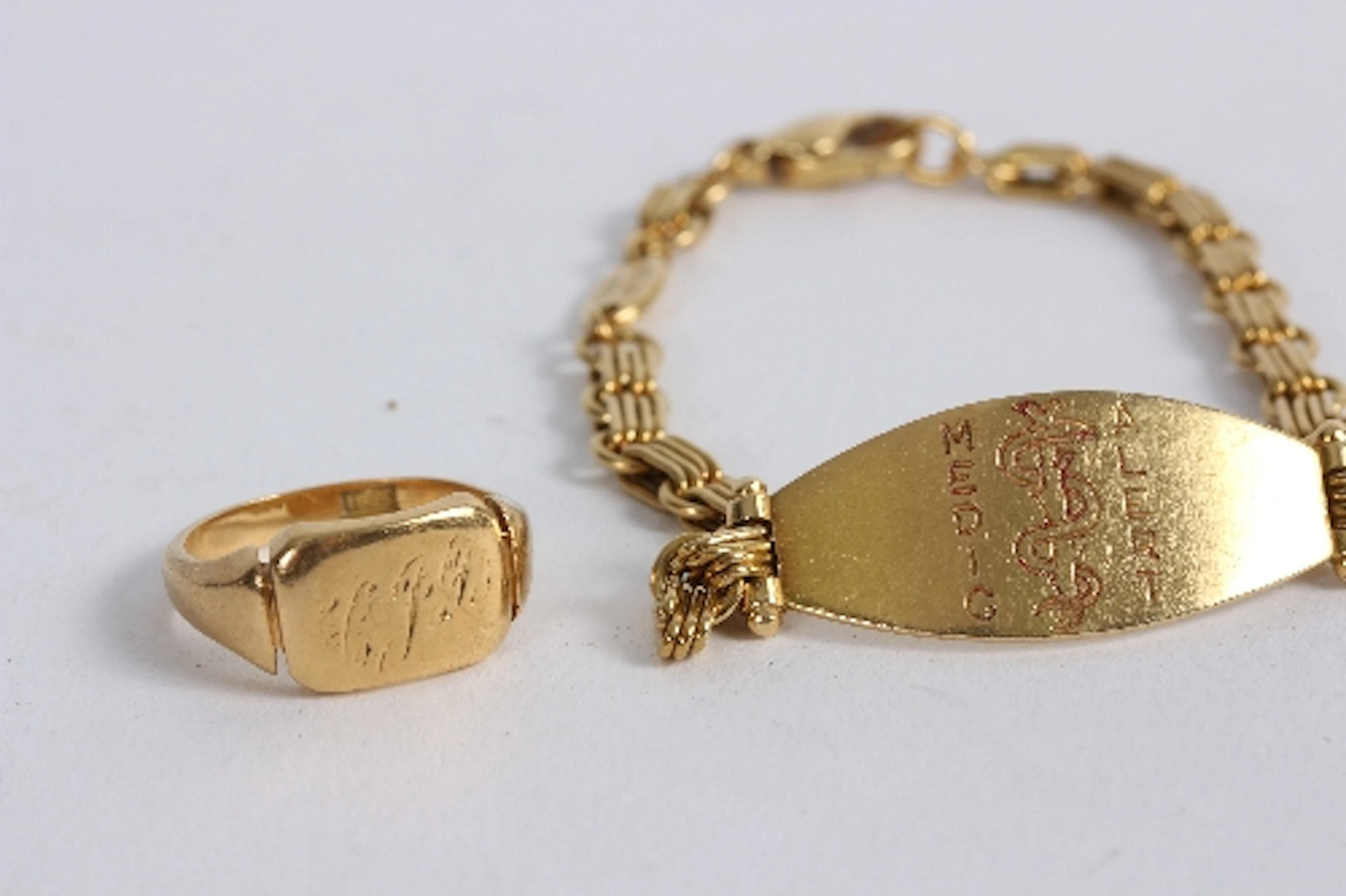 An 18ct gold signet ring and an 18ct gold medic alert bracelet